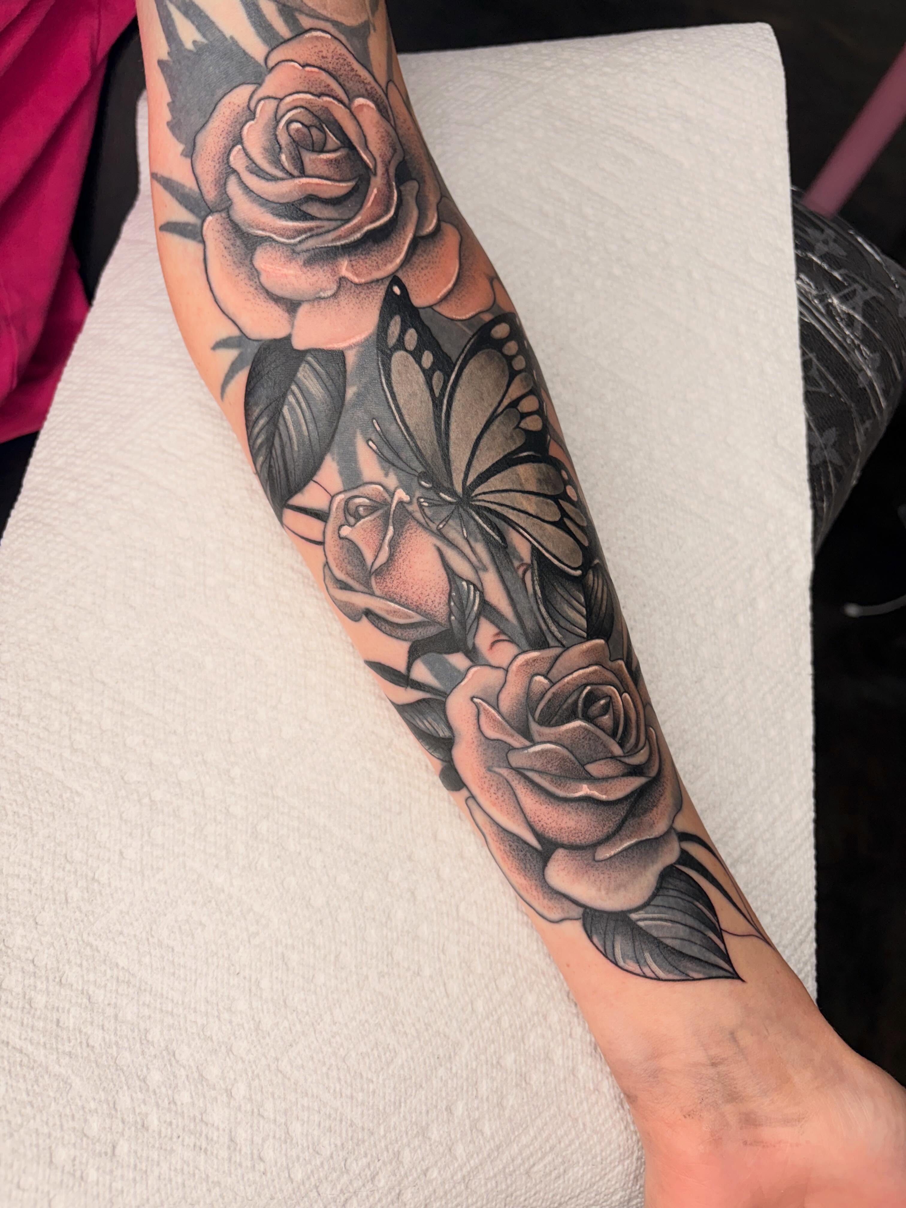 Roses and butterflies realism tattoo on the forearm by Avery Mullins
