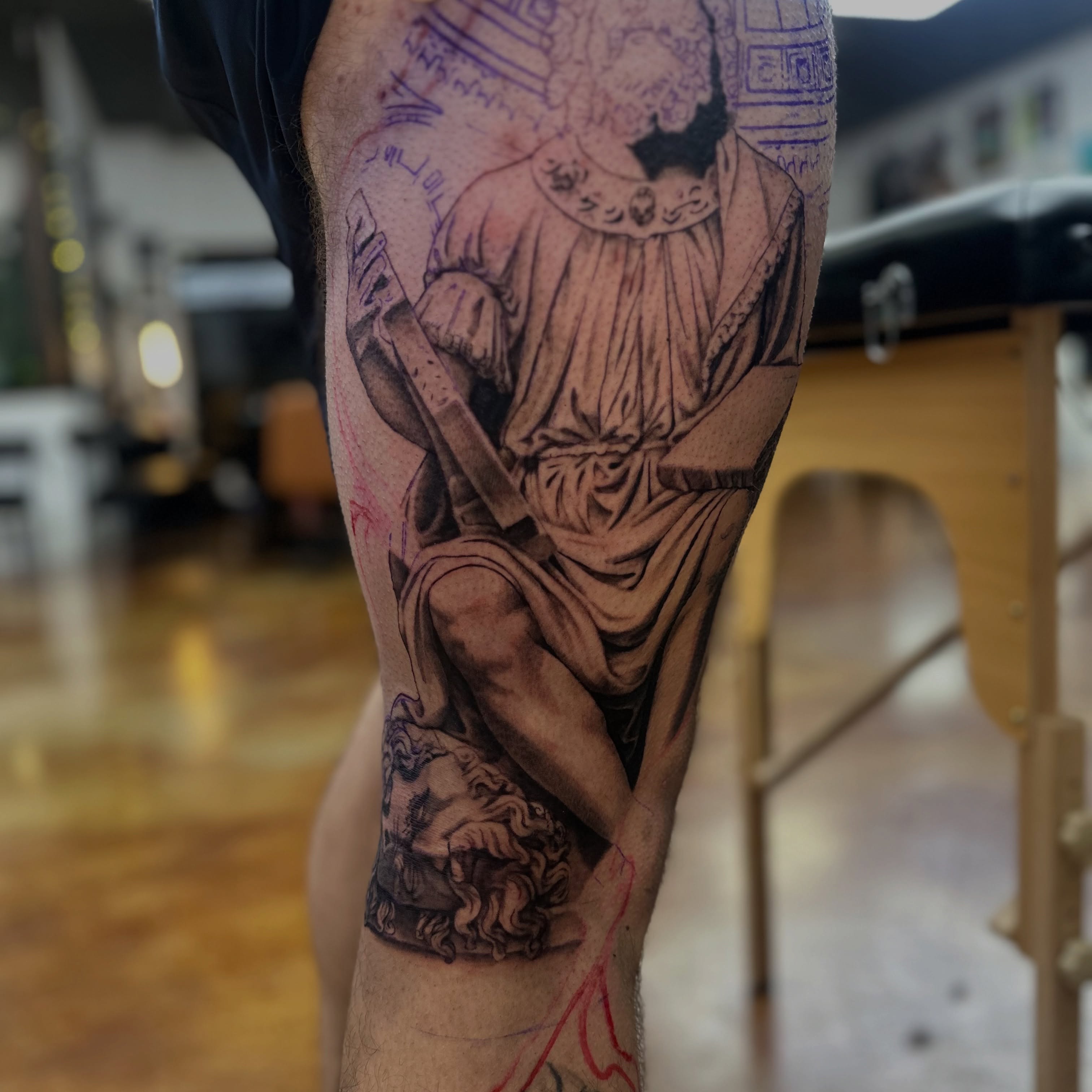Statue of man realism tattoo on the forearm by Trent Hebert