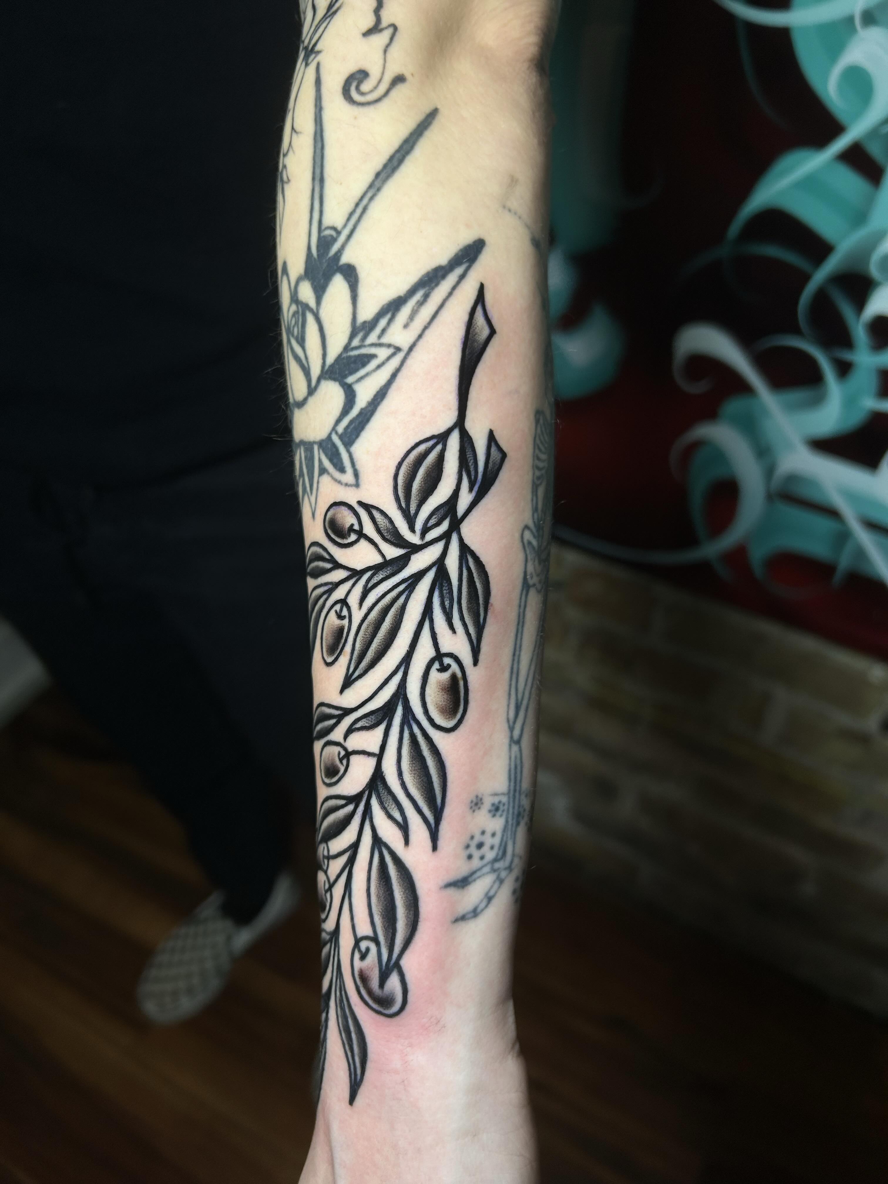Olive branch black and grey tattoo on the forearm by Alycia