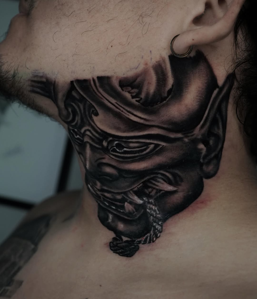 Oni mask on neck Japanese tattoo on the neck by Carlos Trujillo