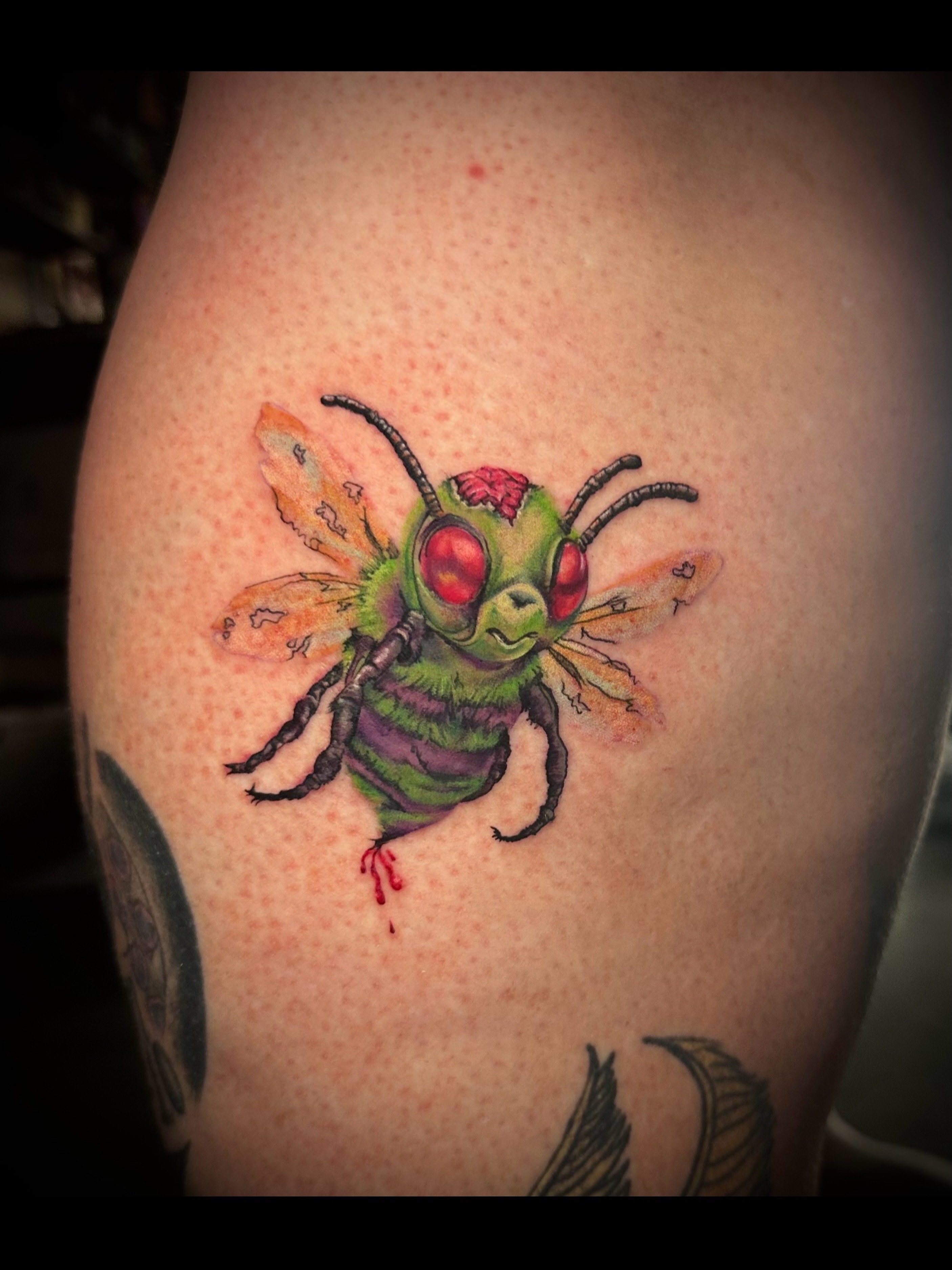 Bee watercolor tattoo on the thigh by Elizabeth’s Eclectic Tattoos