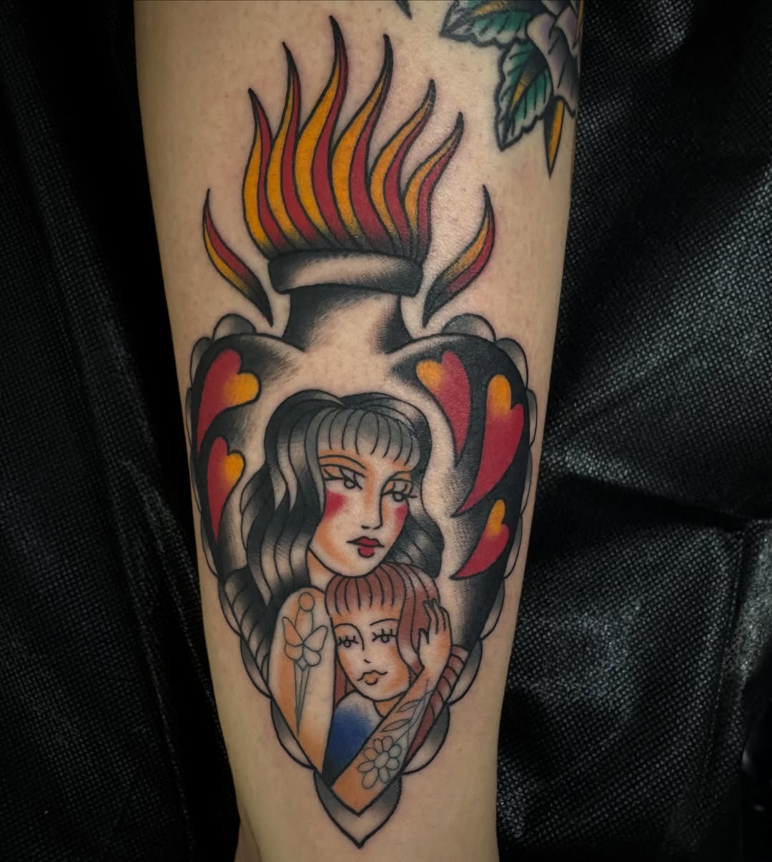 Flame, woman, child American traditional tattoo on the forearm by Allyson Monique