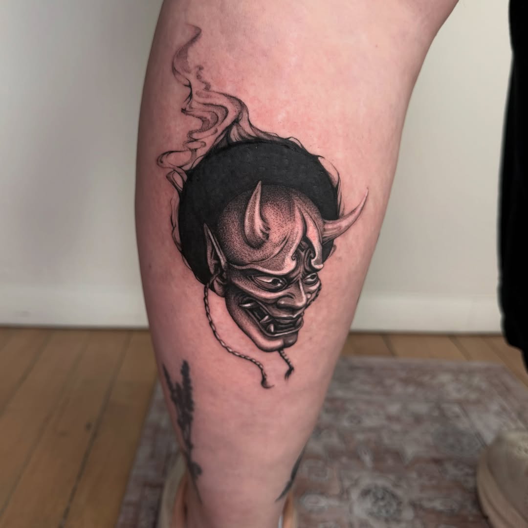 Demon mask dotwork tattoo on the calf by 𓆏 Alyssa Carbonara 𓆏