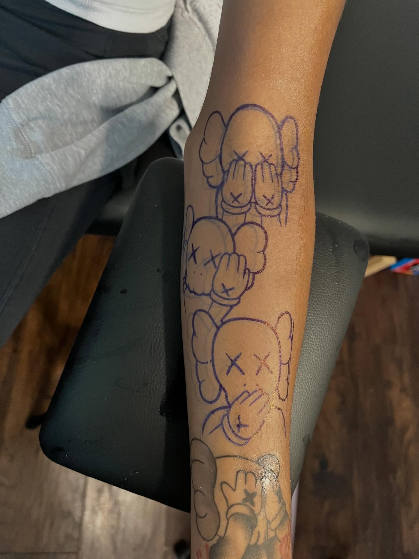 Kaws black and grey tattoo on the forearm by π Westside