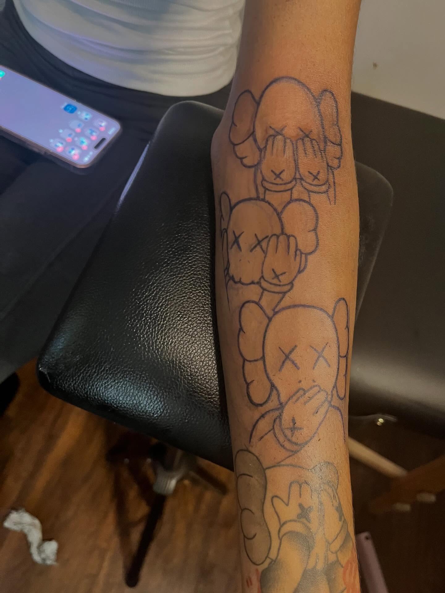 Kaws characters black and grey tattoo on the forearm by π Westside
