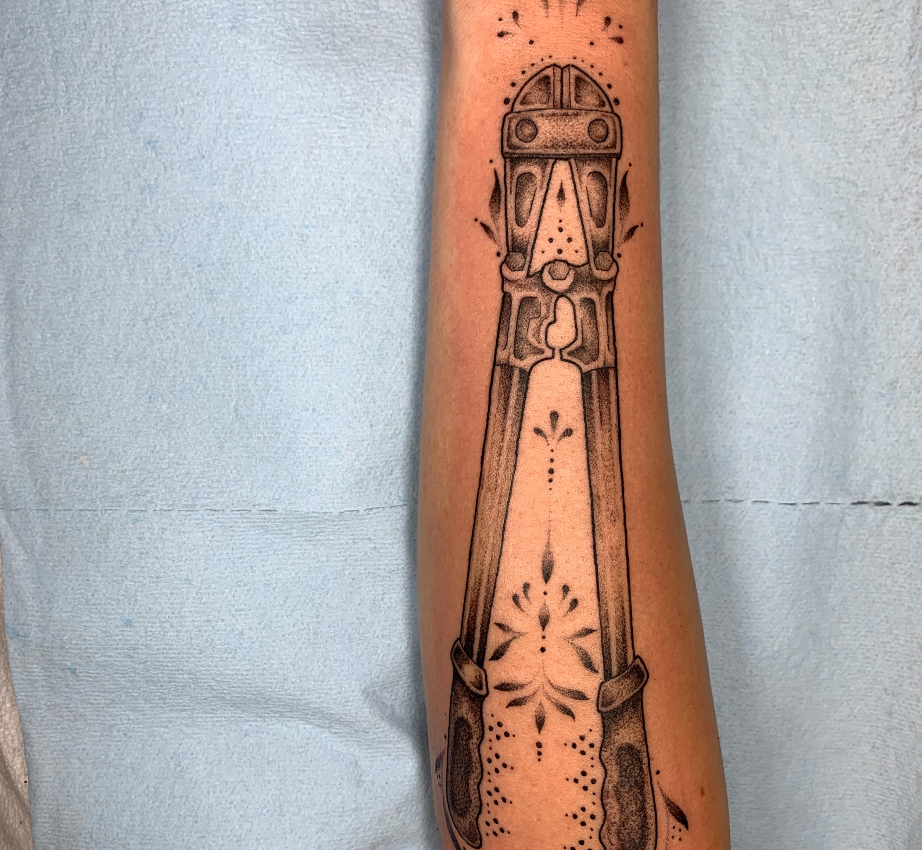 Knife dotwork tattoo on the forearm by Kitty Jones, Berkeley, California