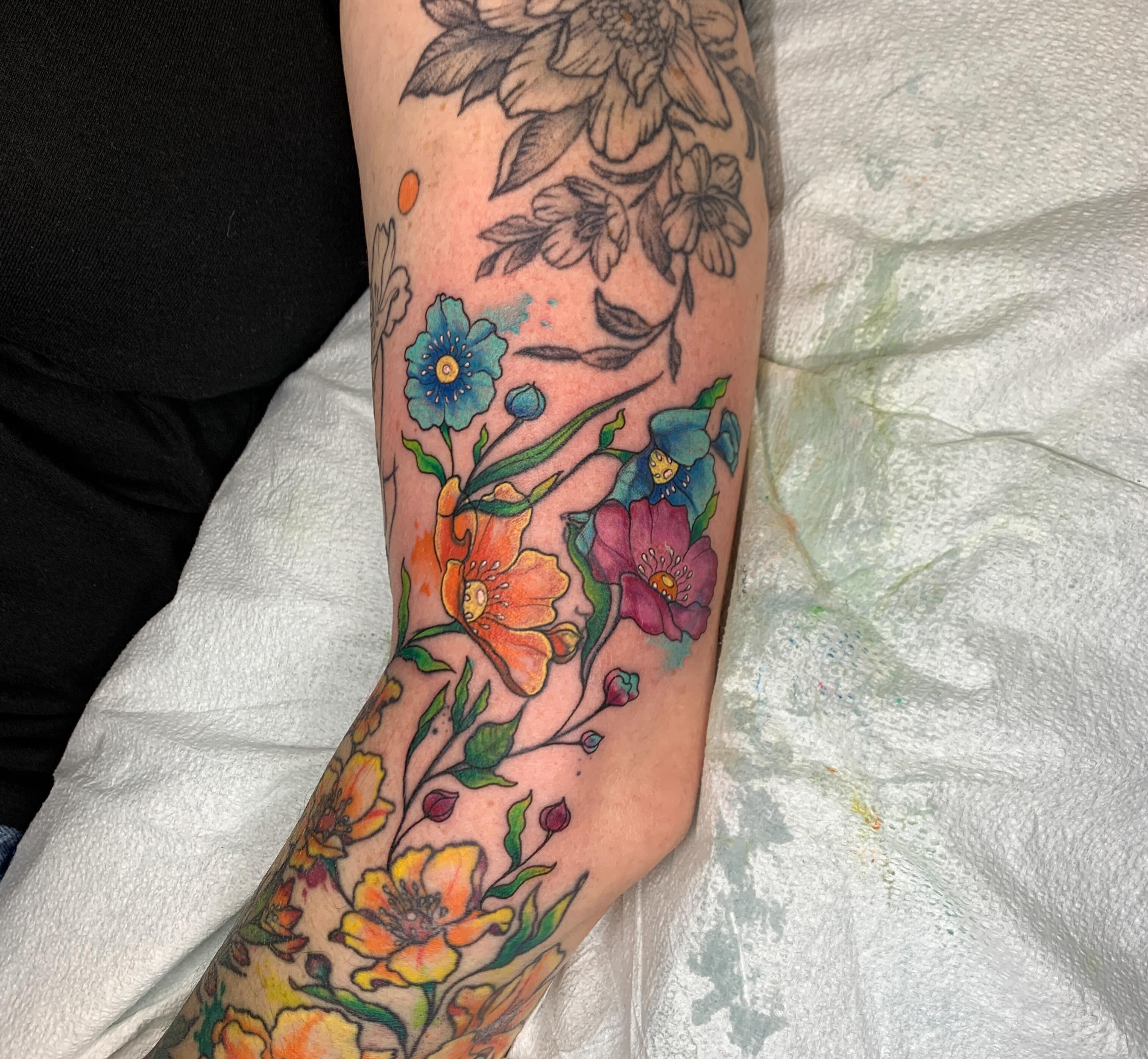 Floral bouquet watercolor tattoo on the forearm by Kitty Jones, Berkeley, California