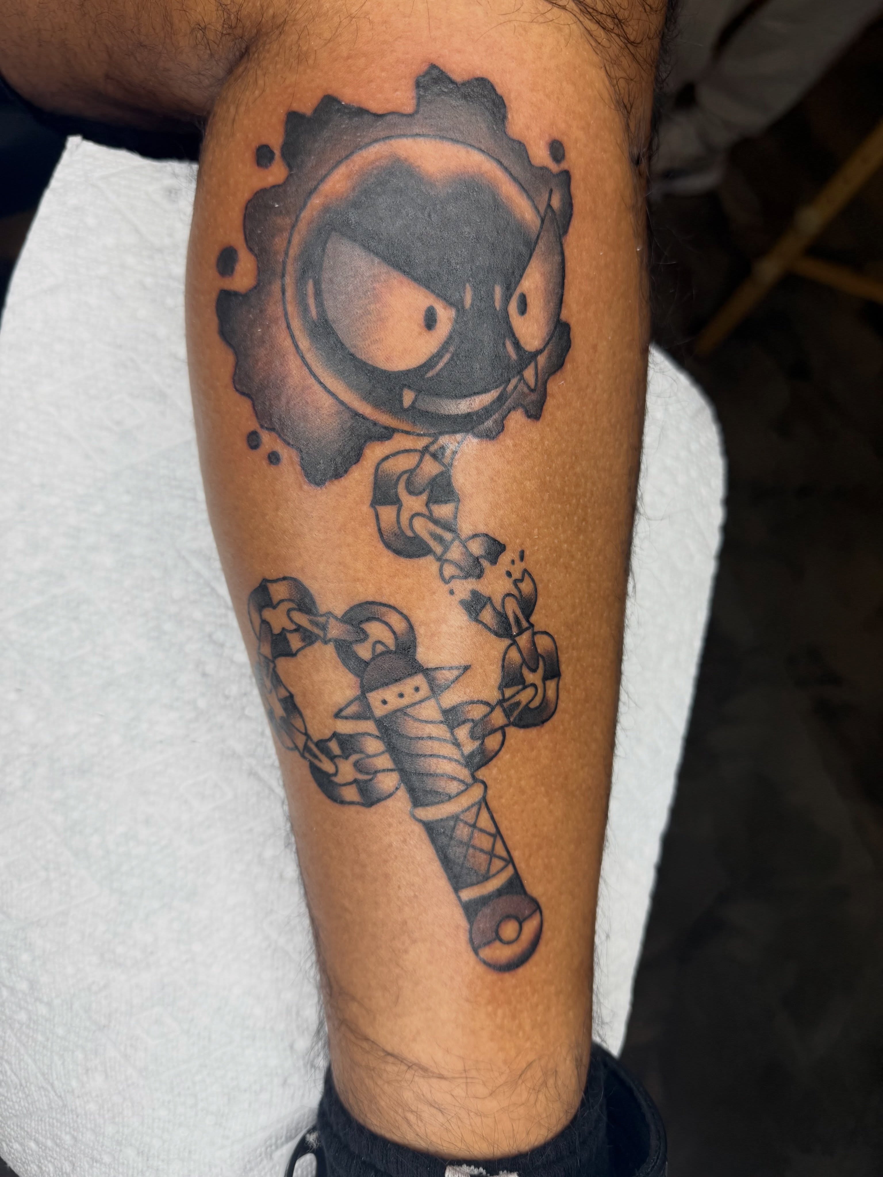 Robotic figure with chains black and grey tattoo on the forearm by @chrisskon, Carpentersville, Illinois