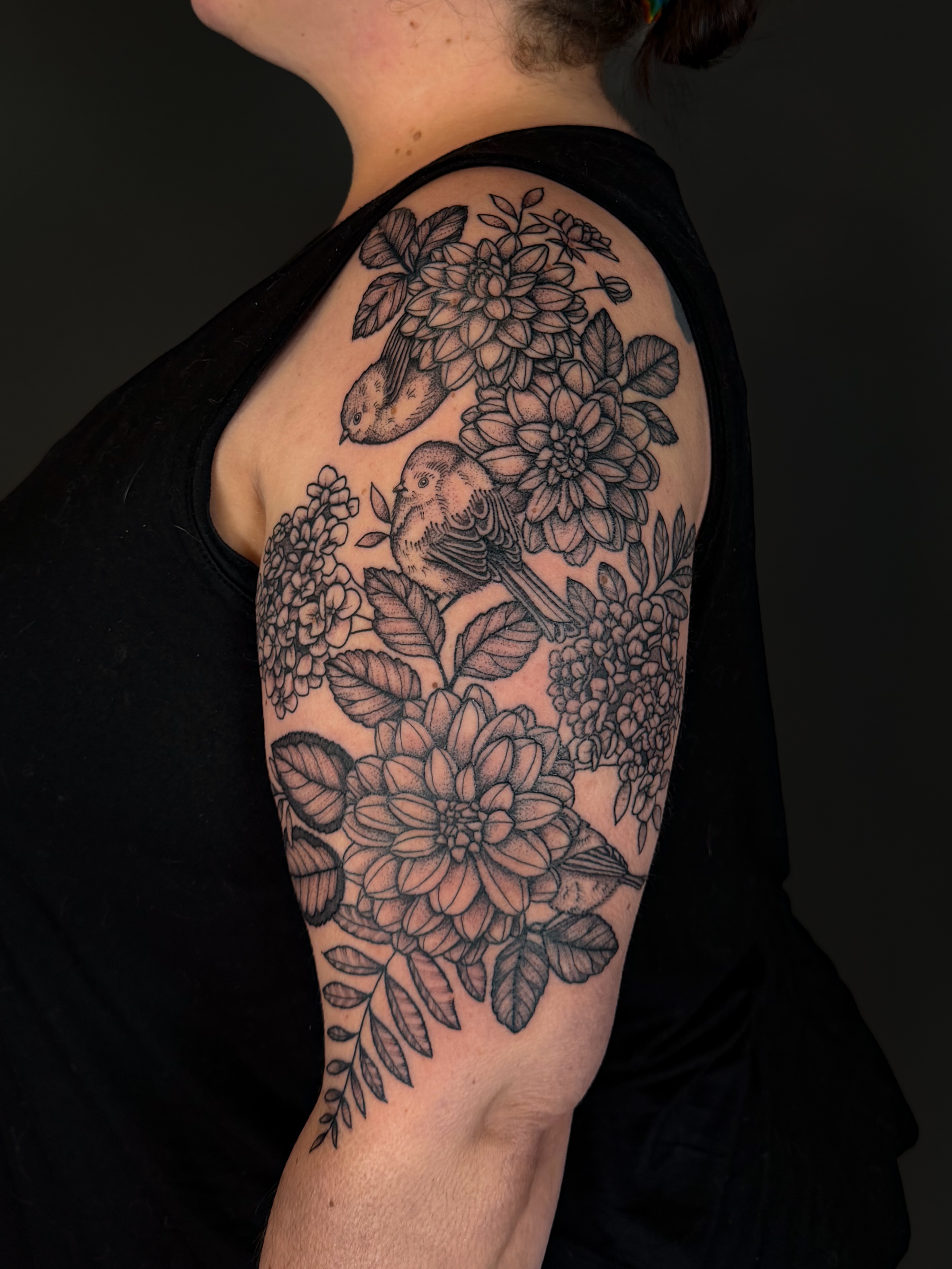 Bird and flowers realism tattoo on the shoulder by Hannah, Portland, Oregon
