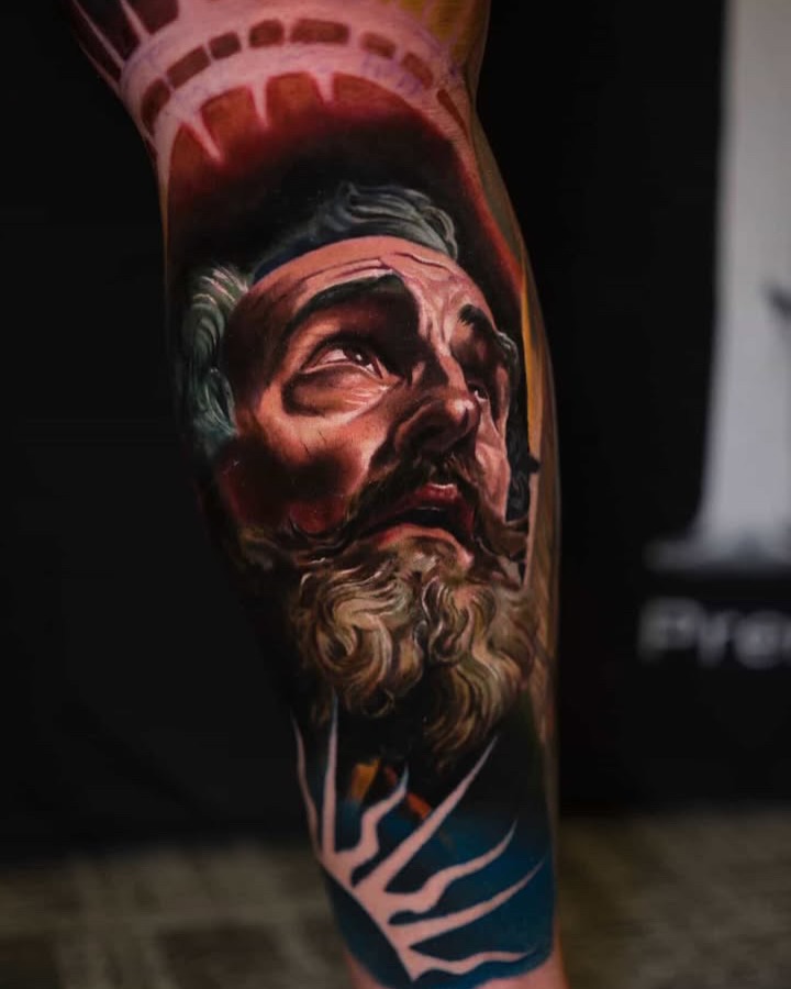 Portrait of a man surrealism tattoo on the forearm by Guillermo Columbie, Houston, Texas