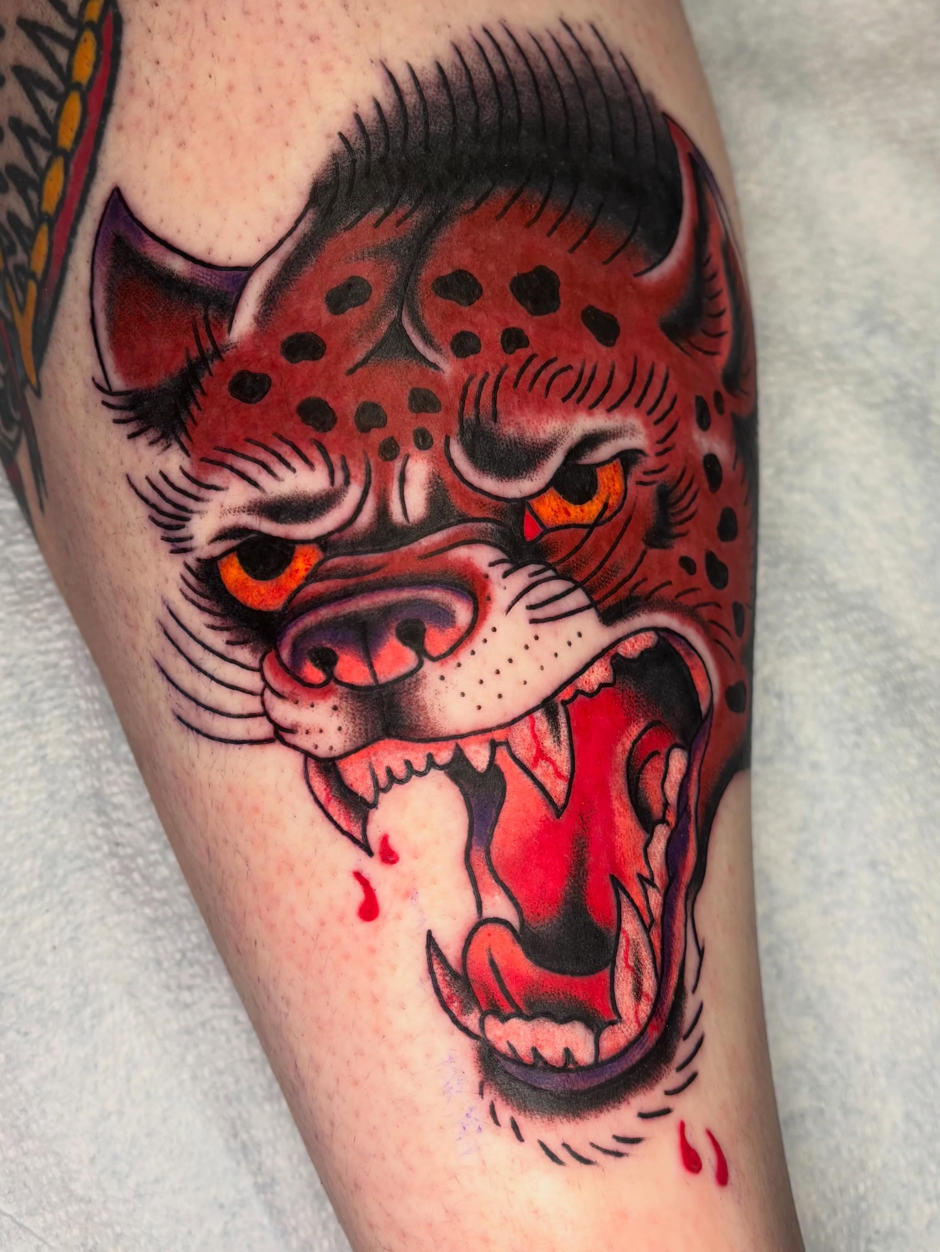 Roaring leopard American traditional tattoo on the thigh by @spicy.curry.tattoos