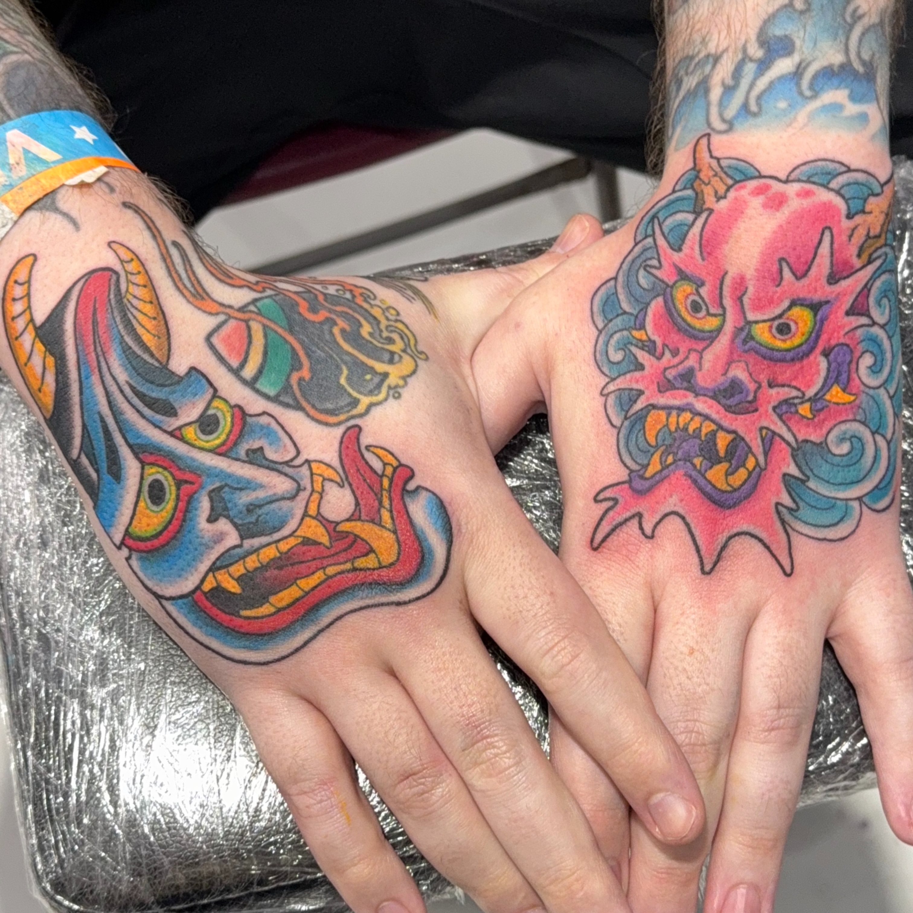 Demon mask American traditional tattoo on the hand by James Bird, Vancouver, British Columbia