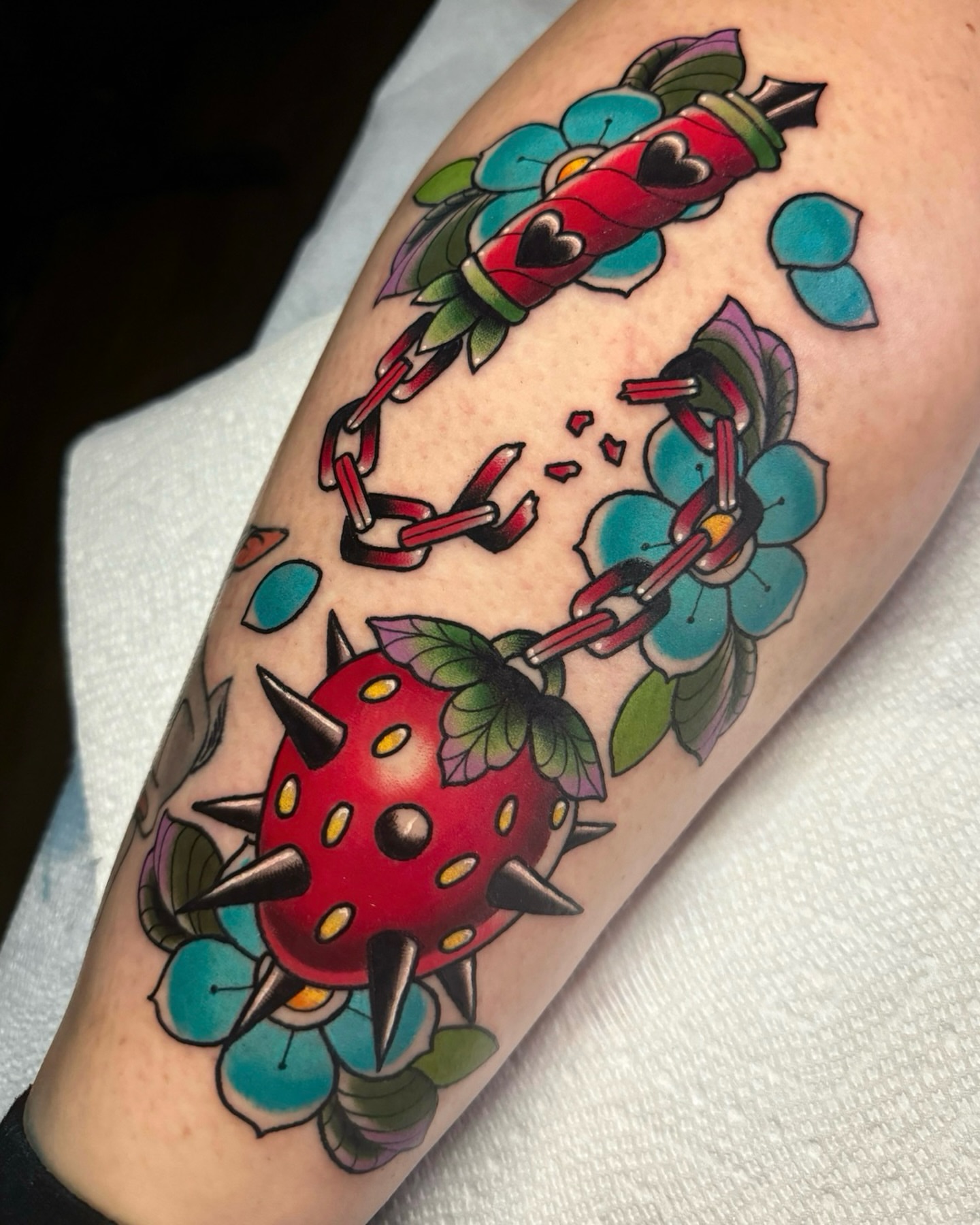 Spiky strawberry American traditional tattoo on the forearm by 𝔎𝔦𝔯𝔞 𝔅𝔦𝔰𝔥𝔬𝔭