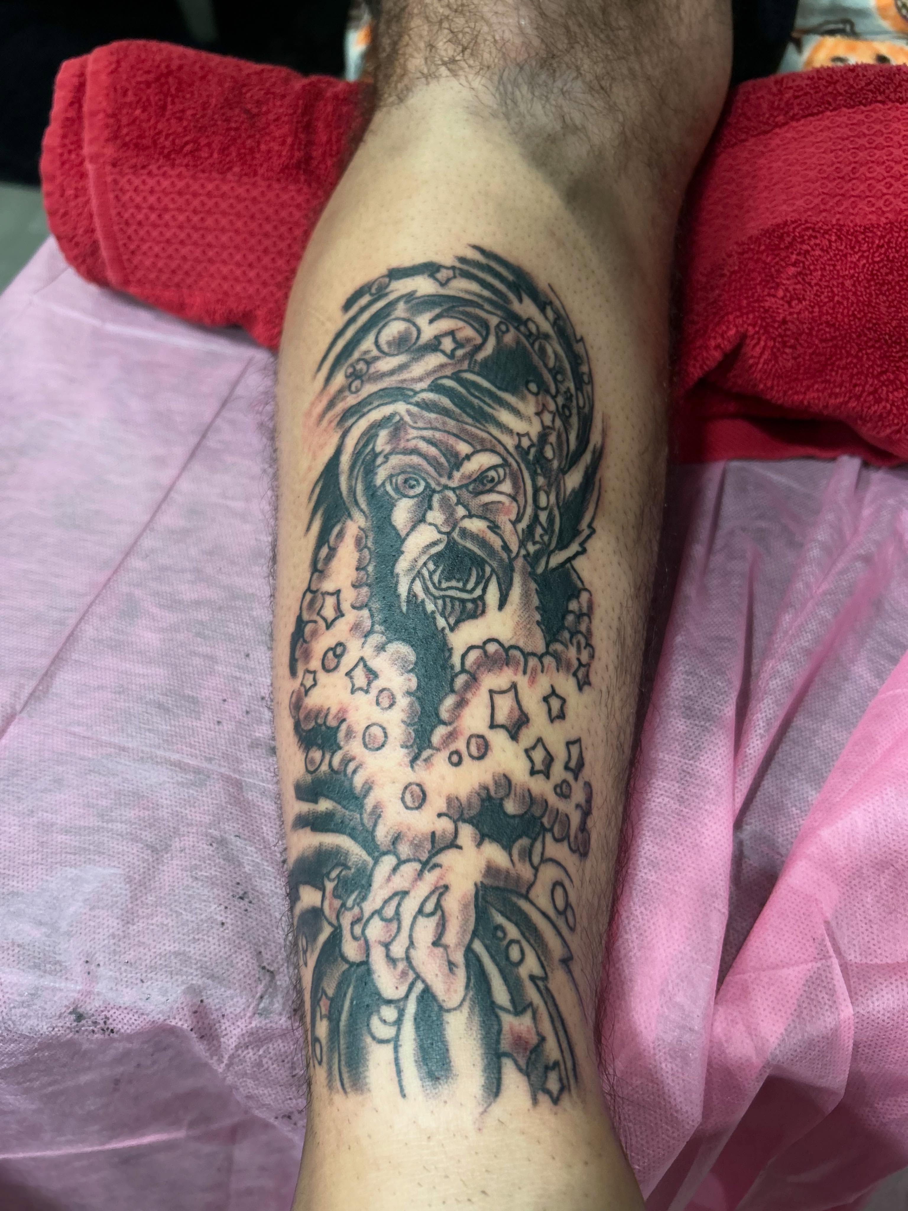 Angry face with stars American traditional tattoo on the forearm by Stogie Tony