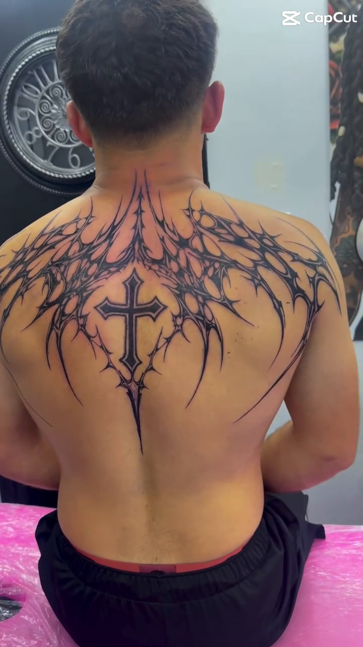 Cross with abstract wings blackwork tattoo by Anwon Johnson