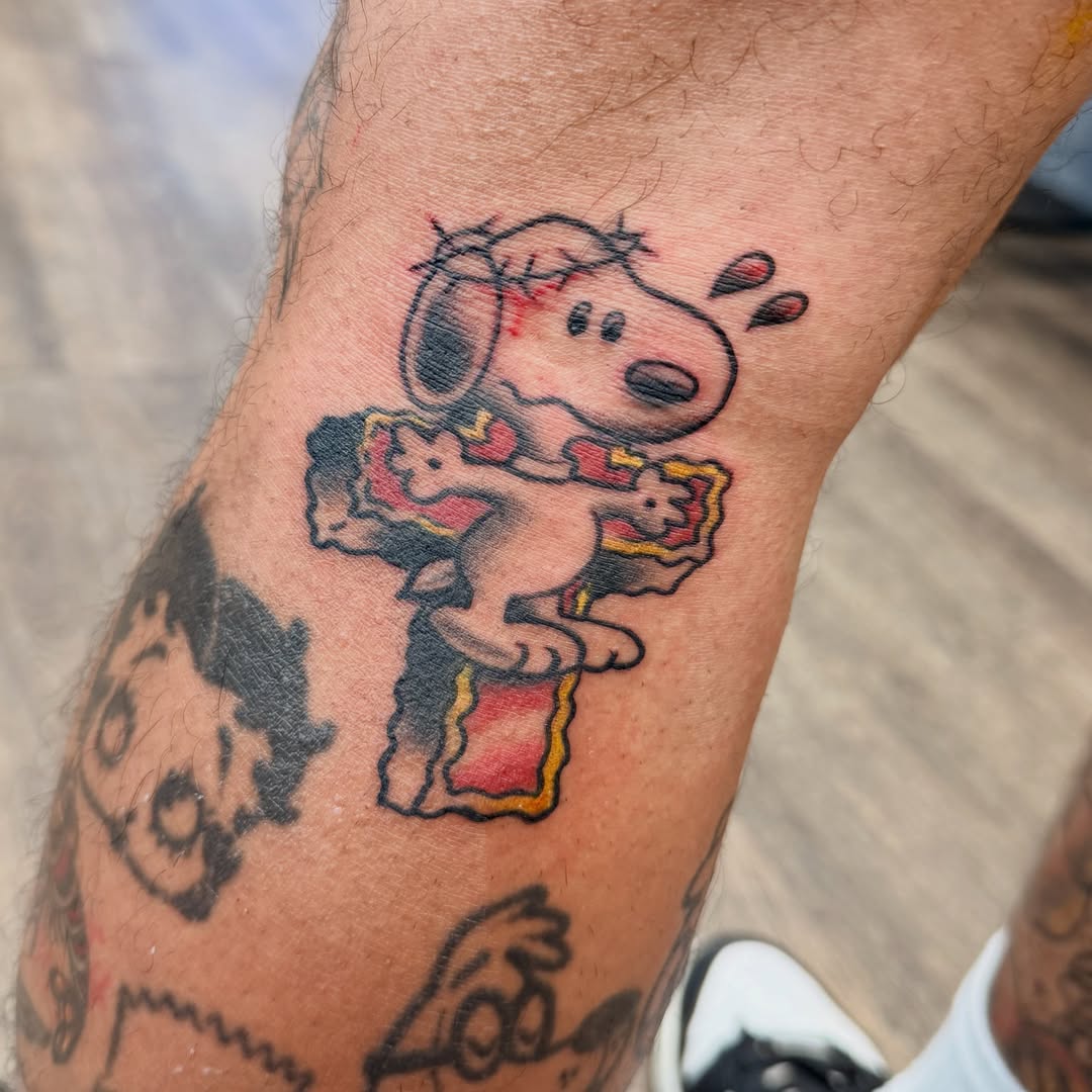 Snoopy American traditional tattoo on the forearm by Chris