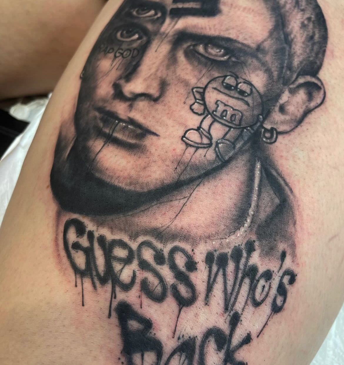 Portrait with M&M character realism tattoo on the upper arm by Cameron Scofield