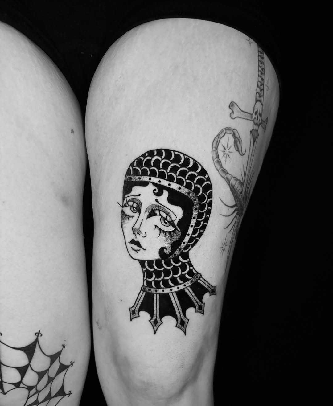 Woman in knight helmet black and grey tattoo on the thigh by ✠ courtney jorée ✠