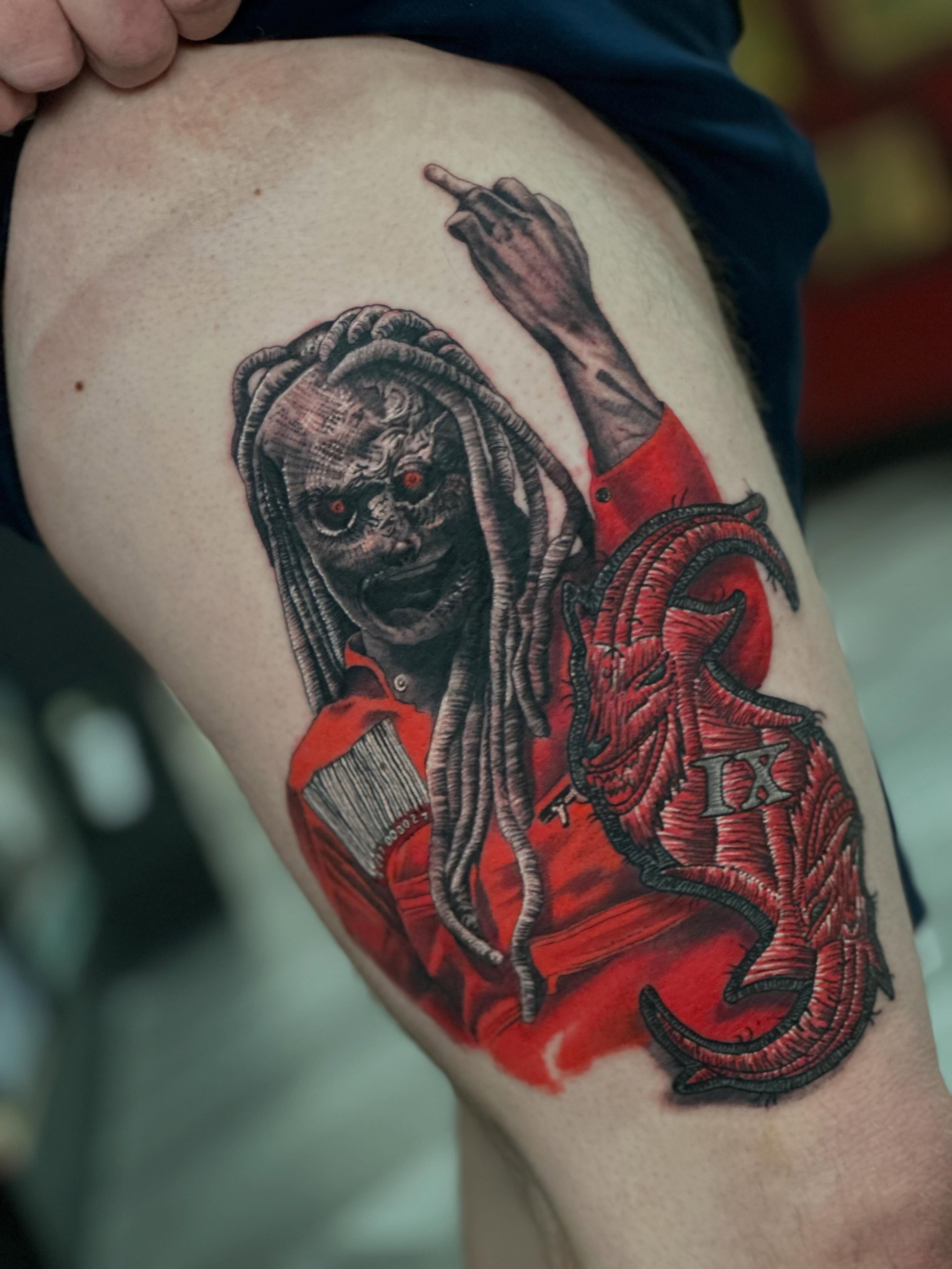 Dreadlocked figure with red shirt realism tattoo on the thigh by 𝐖𝐄𝐒