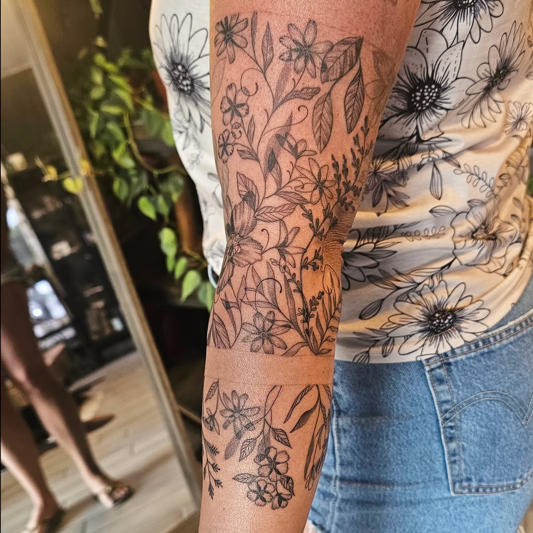 Floral design black and grey tattoo on the forearm by Casey Jo