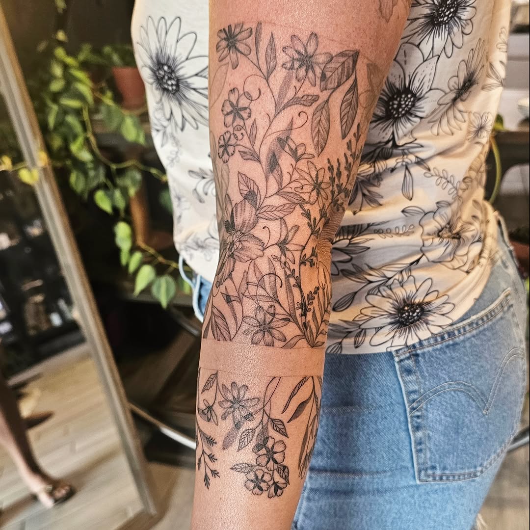 Floral design black and grey tattoo on the forearm by Casey Jo