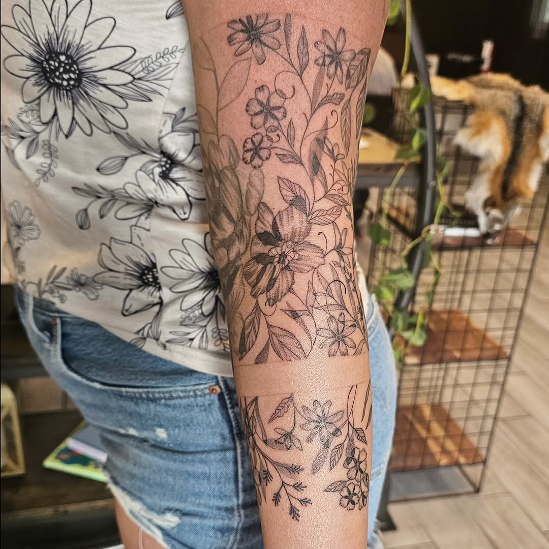 Floral design black and grey tattoo on the forearm by Casey Jo