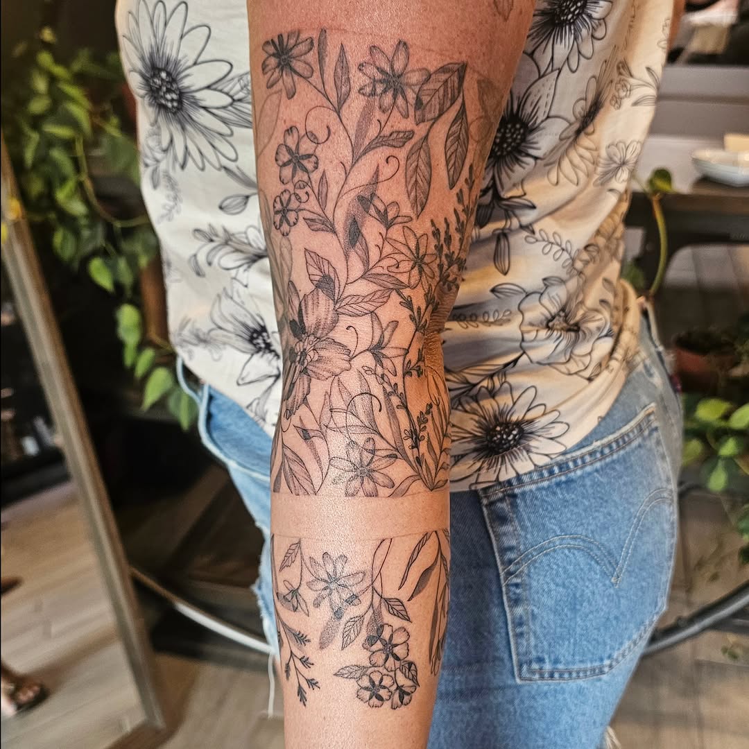 Floral design black and grey tattoo on the forearm by Casey Jo