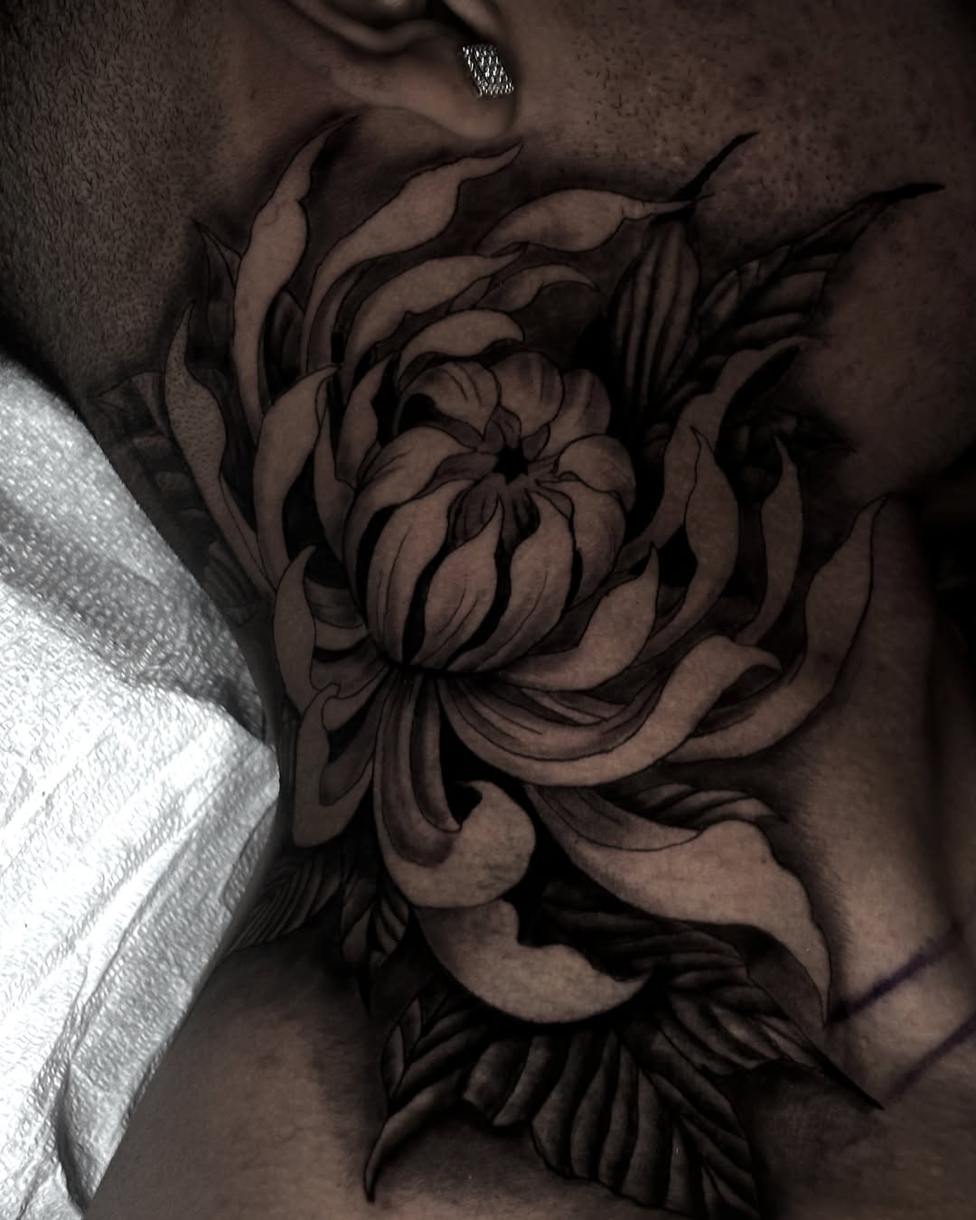Flower black and grey tattoo on the chest by Trev