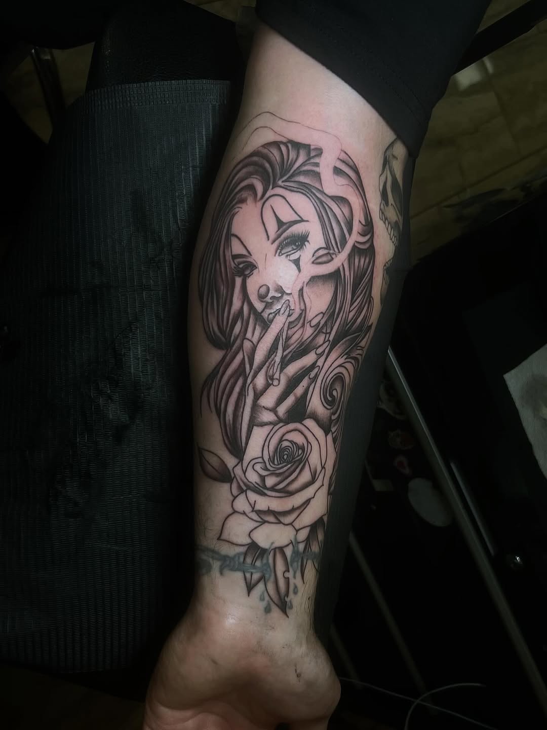 Clown woman smoking with rose realism tattoo on the forearm by π’ππ΅π΅π΄ π©°π