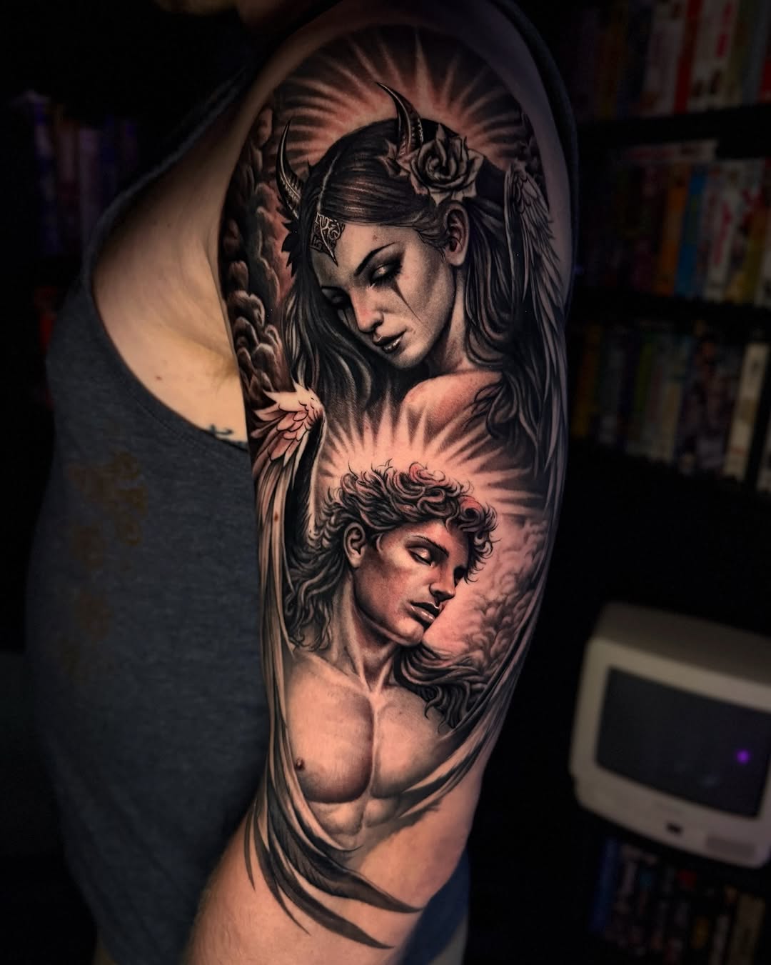 Angel and demon figures realism tattoo on the forearm by Tommy Nguyen, Eastpointe, Michigan