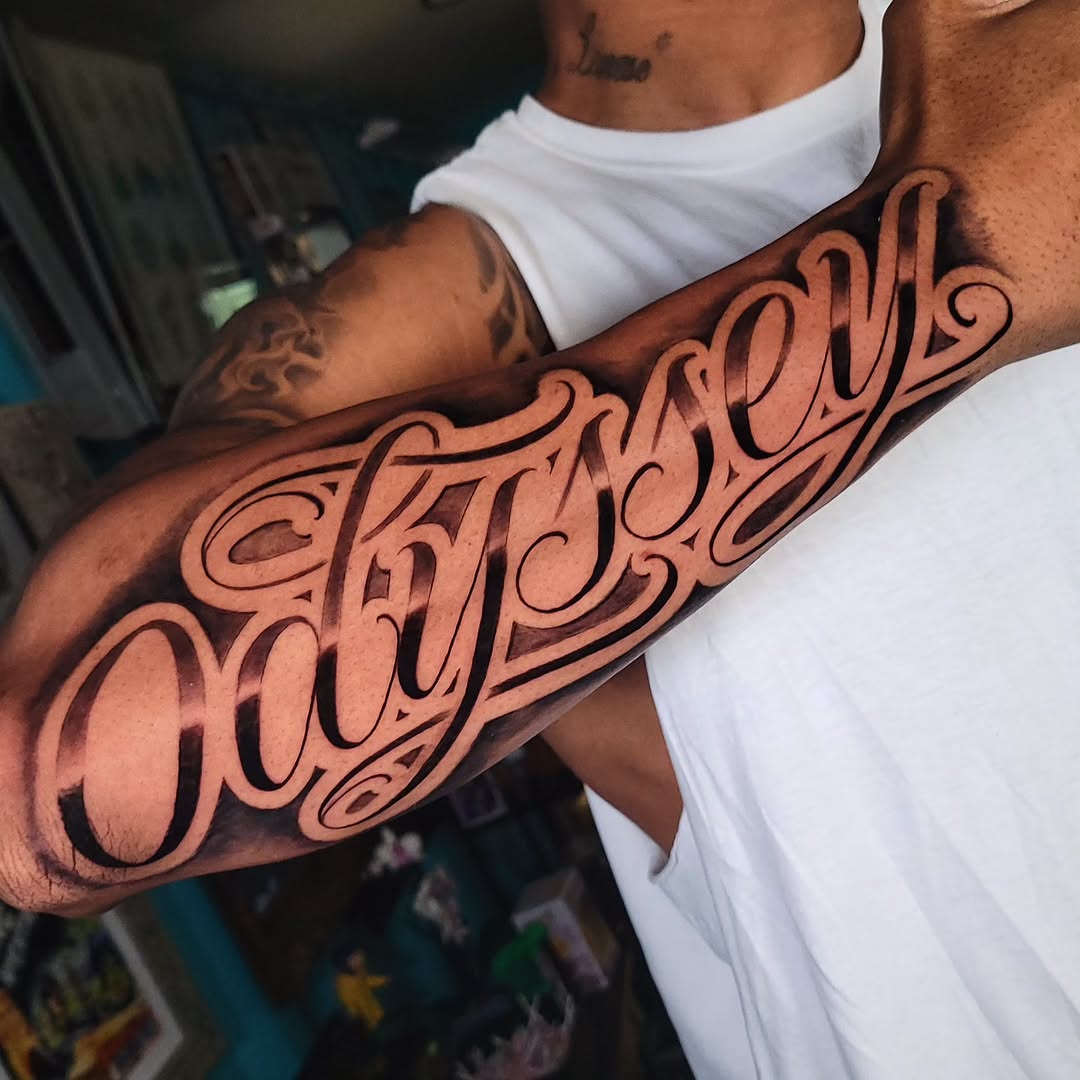 Odyssey script lettering lettering tattoo on the forearm by Brandon Rabago, Fort Worth, Texas