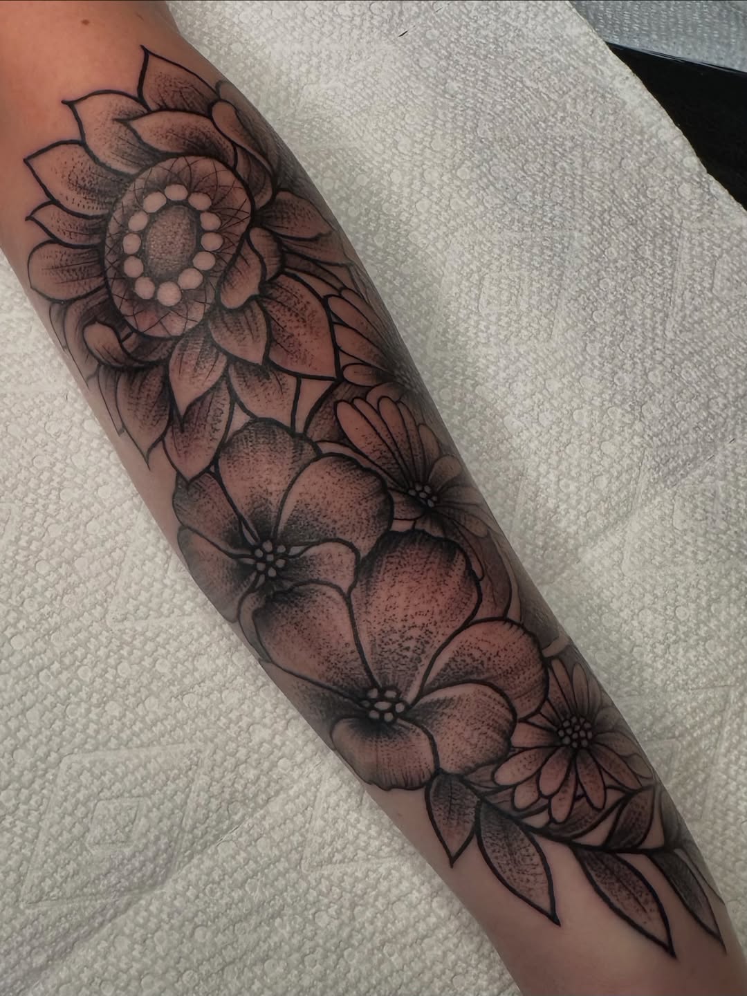 Floral arrangement dotwork tattoo on the forearm by Lisa Nikolopoulos, New York, New York