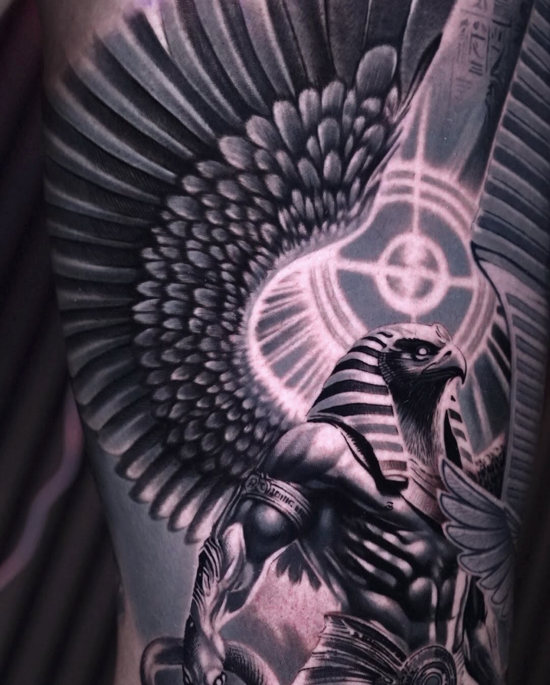 Egyptian deity with wings realism tattoo on the upper arm by Sadier Alfonso