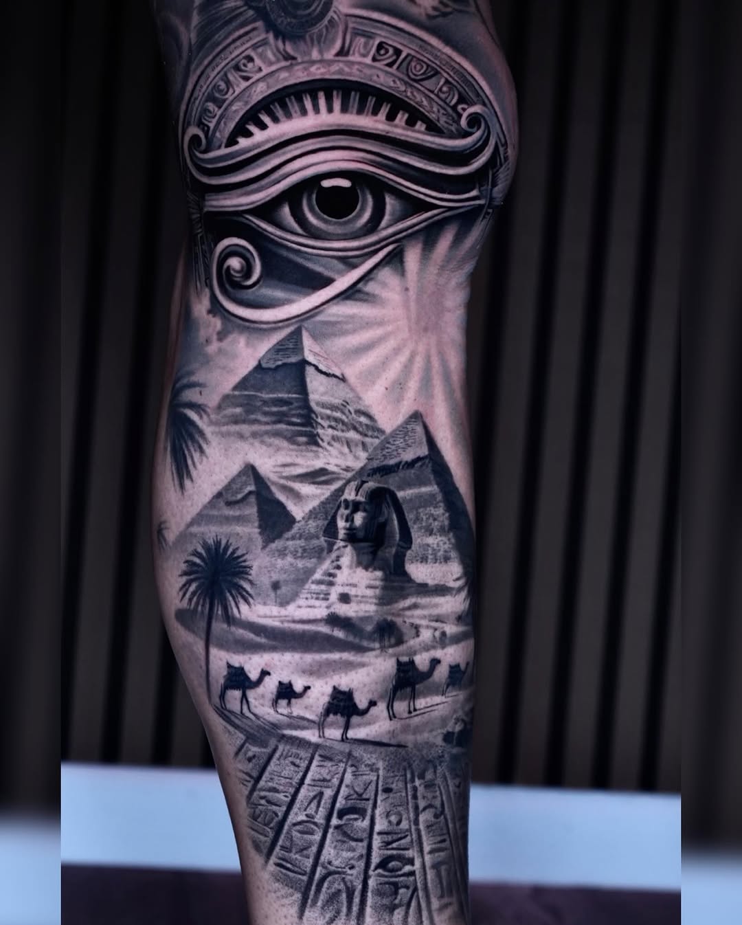 Egyptian landscape with eye of Horus surrealism tattoo on the forearm by Sadier Alfonso