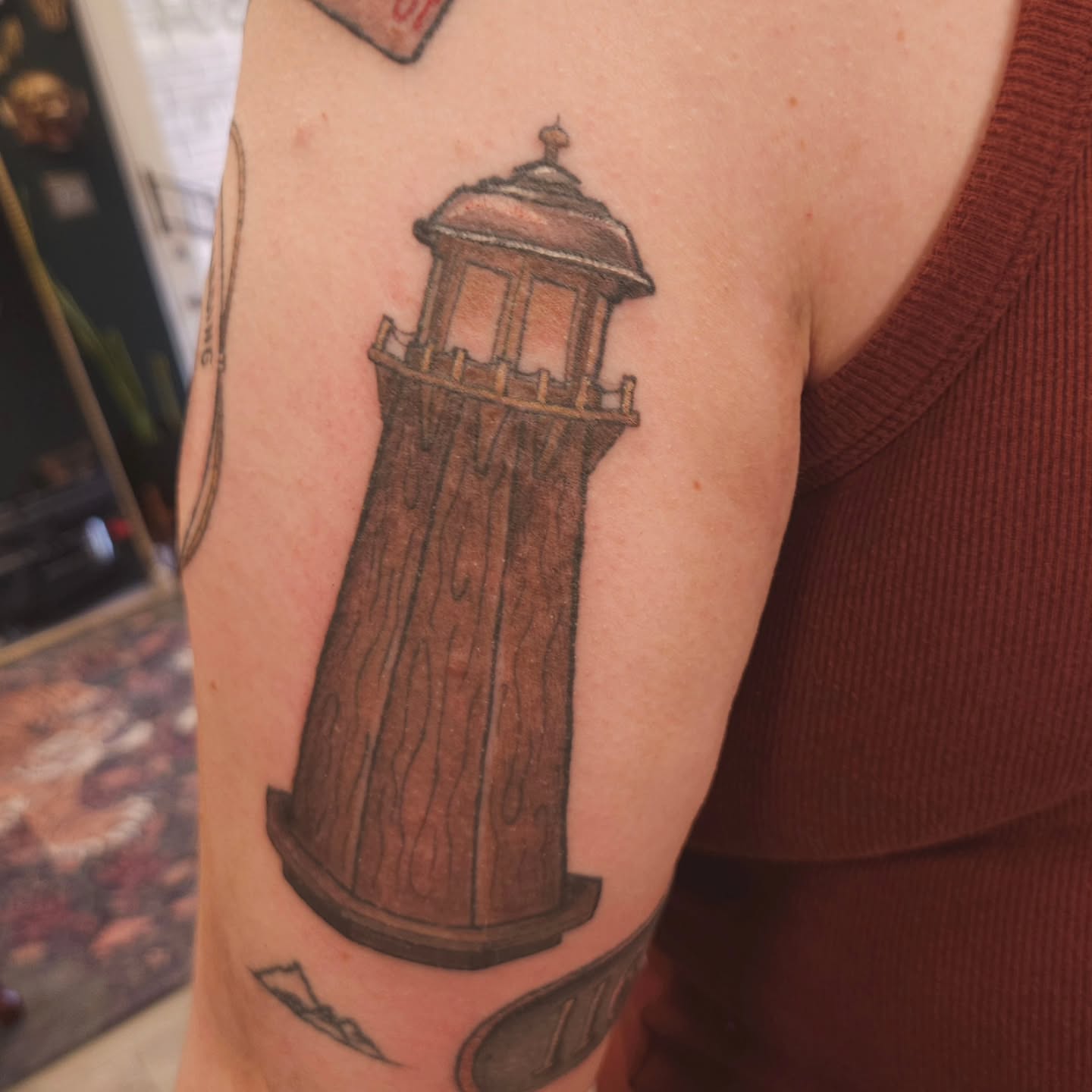 Wooden lighthouse black and grey tattoo on the forearm by πΎπππππ πΎπππππ