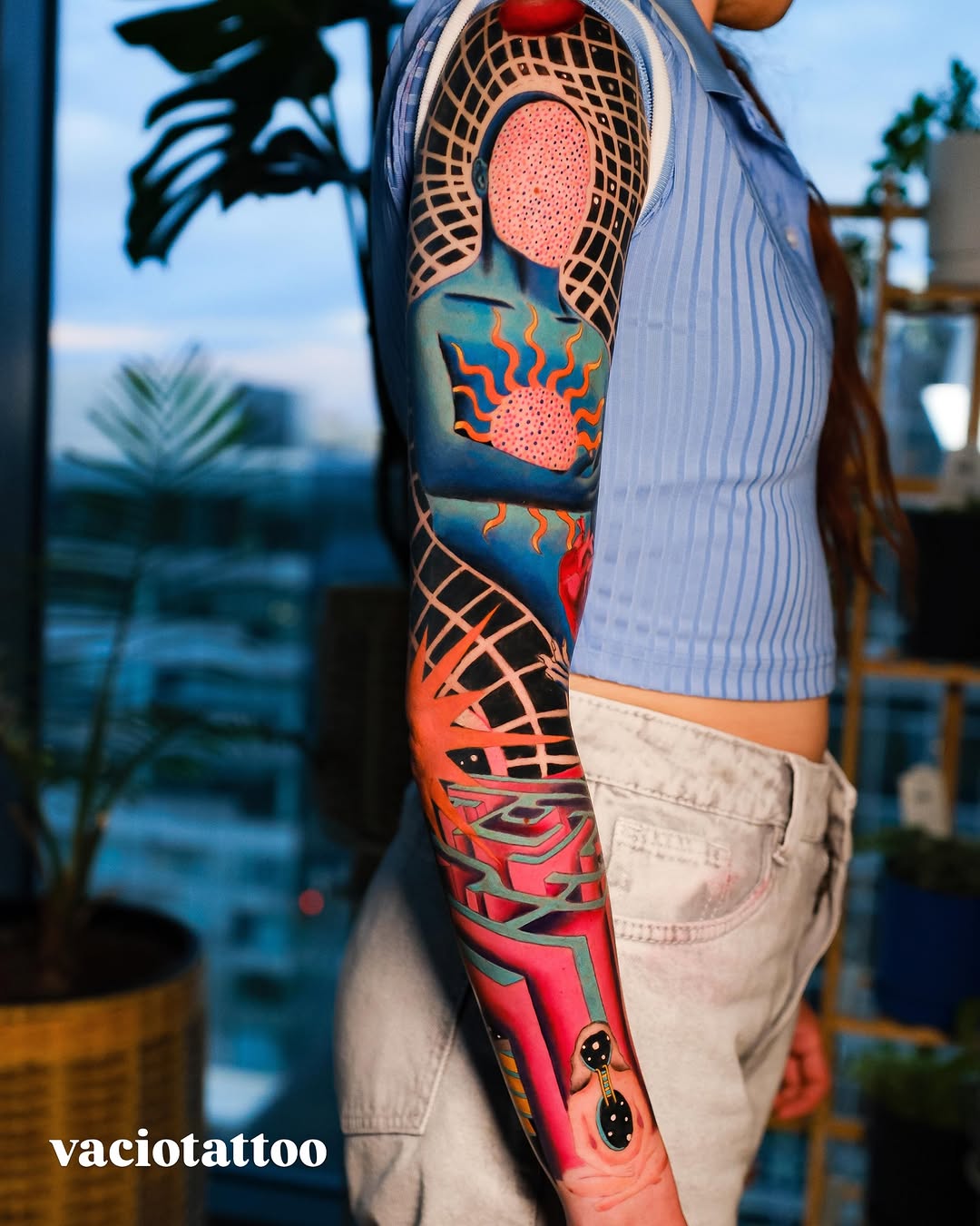 Surrealism tattoo on the upper arm by Andres Acevedo, Denver, Colorado