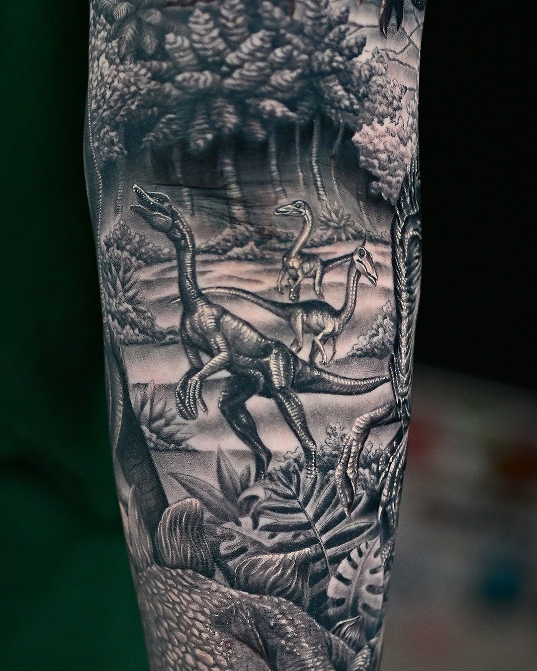 Dinosaur scene realism tattoo on the forearm by Sean OHara