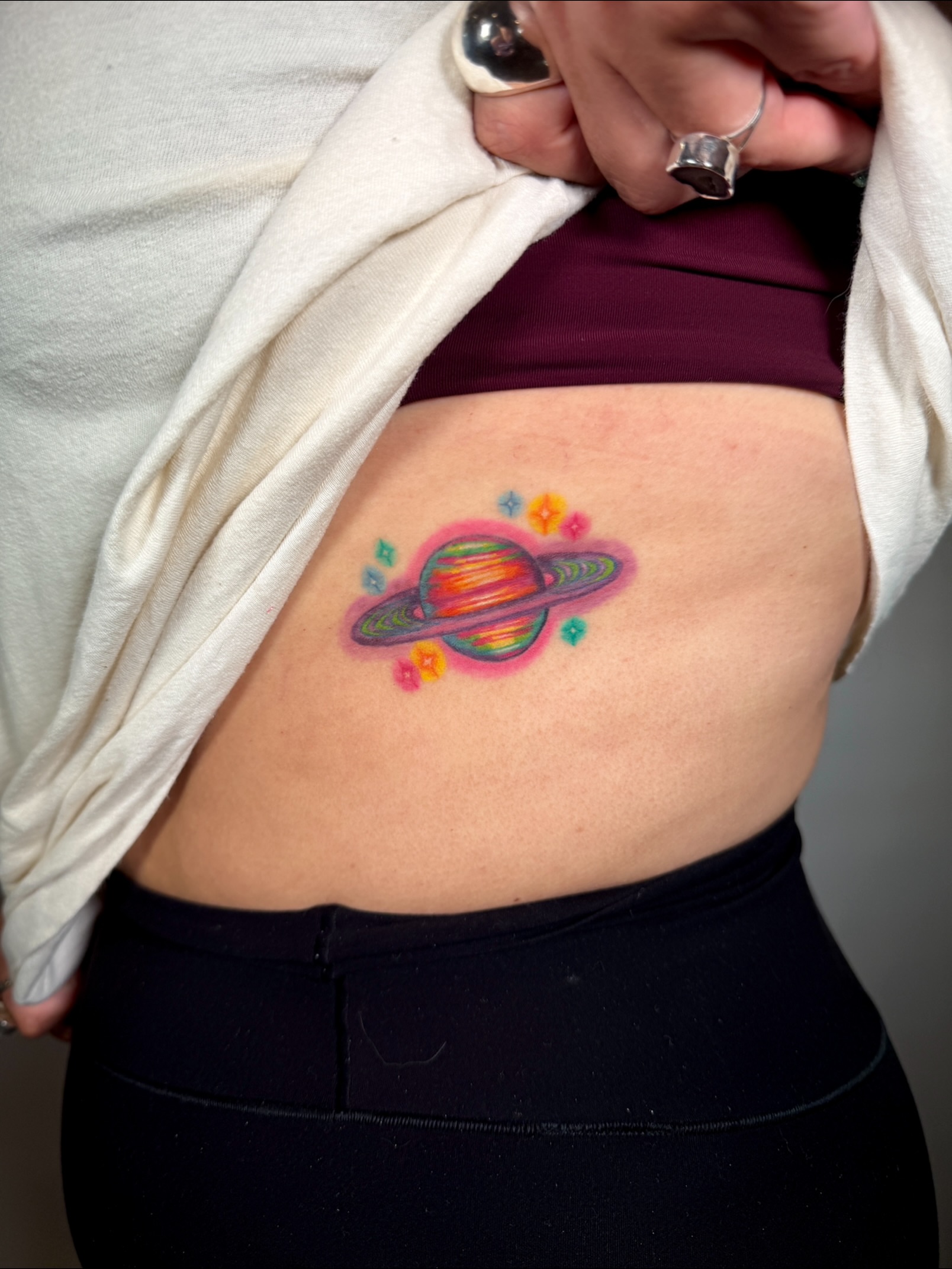 Planetary ring system new school tattoo on the torso by aria, Austin, Texas