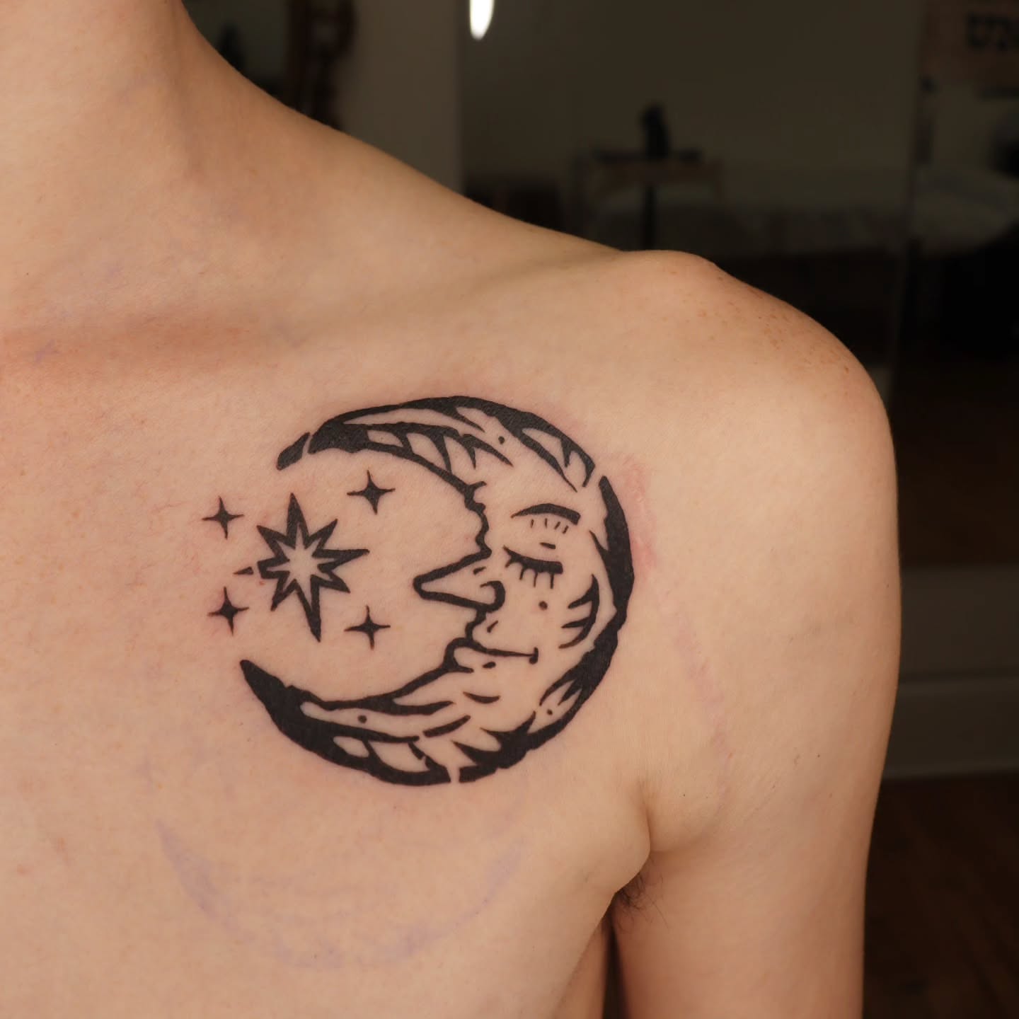 Moon and stars black and grey tattoo on the shoulder by Veronika Lipchak