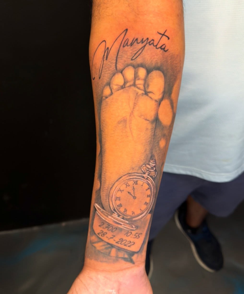 Footprint with clock realism tattoo on the forearm by David Yancy III