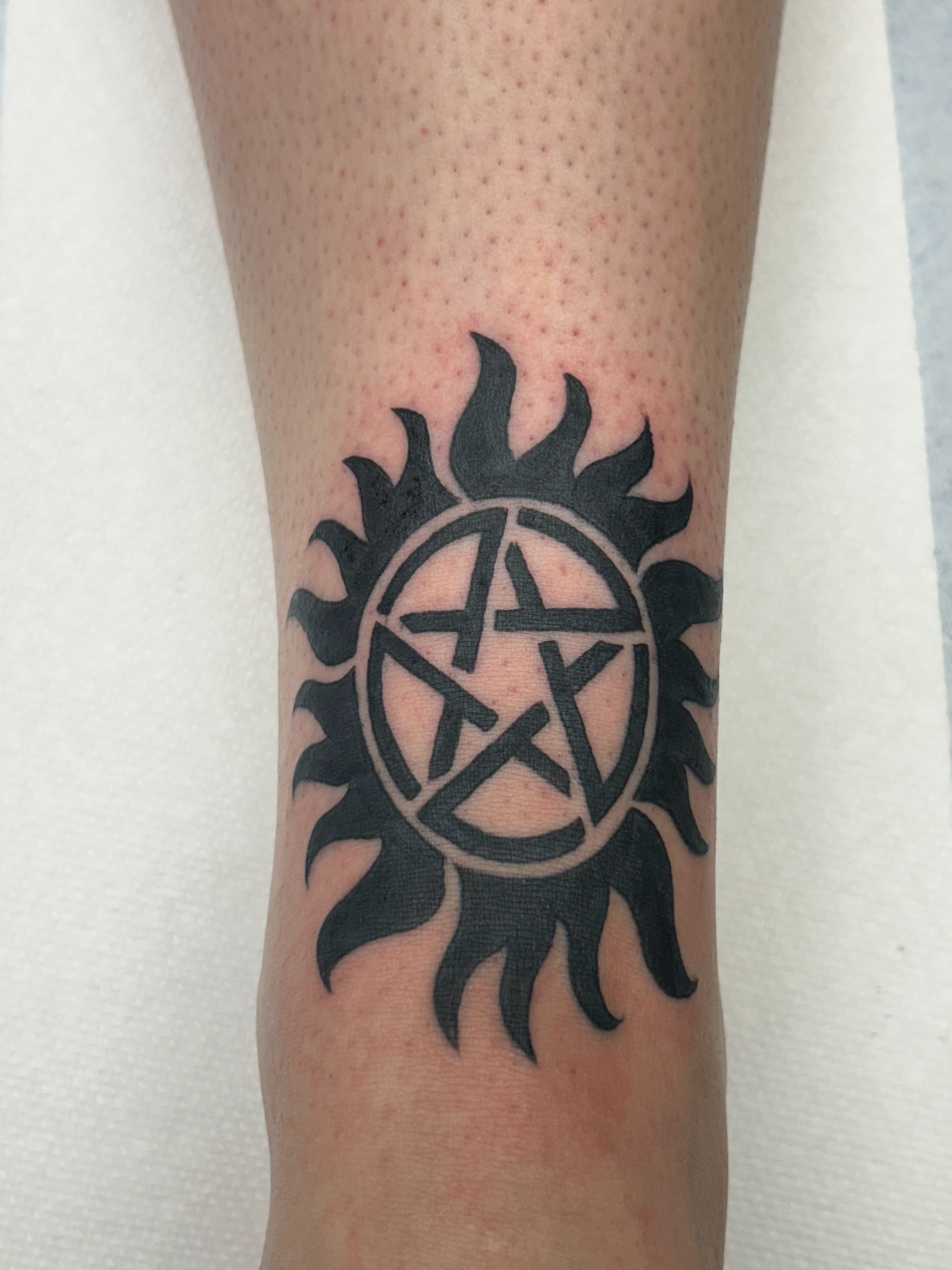 Anti-possession symbol black and grey tattoo on the forearm by Michelle Balhan
