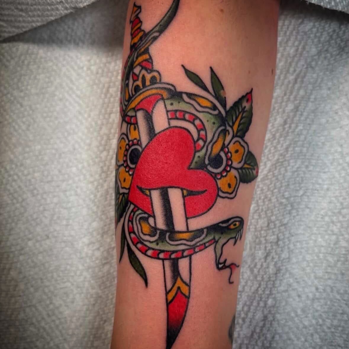 Mushroom and snake American traditional tattoo on the forearm by Caeli Martin
