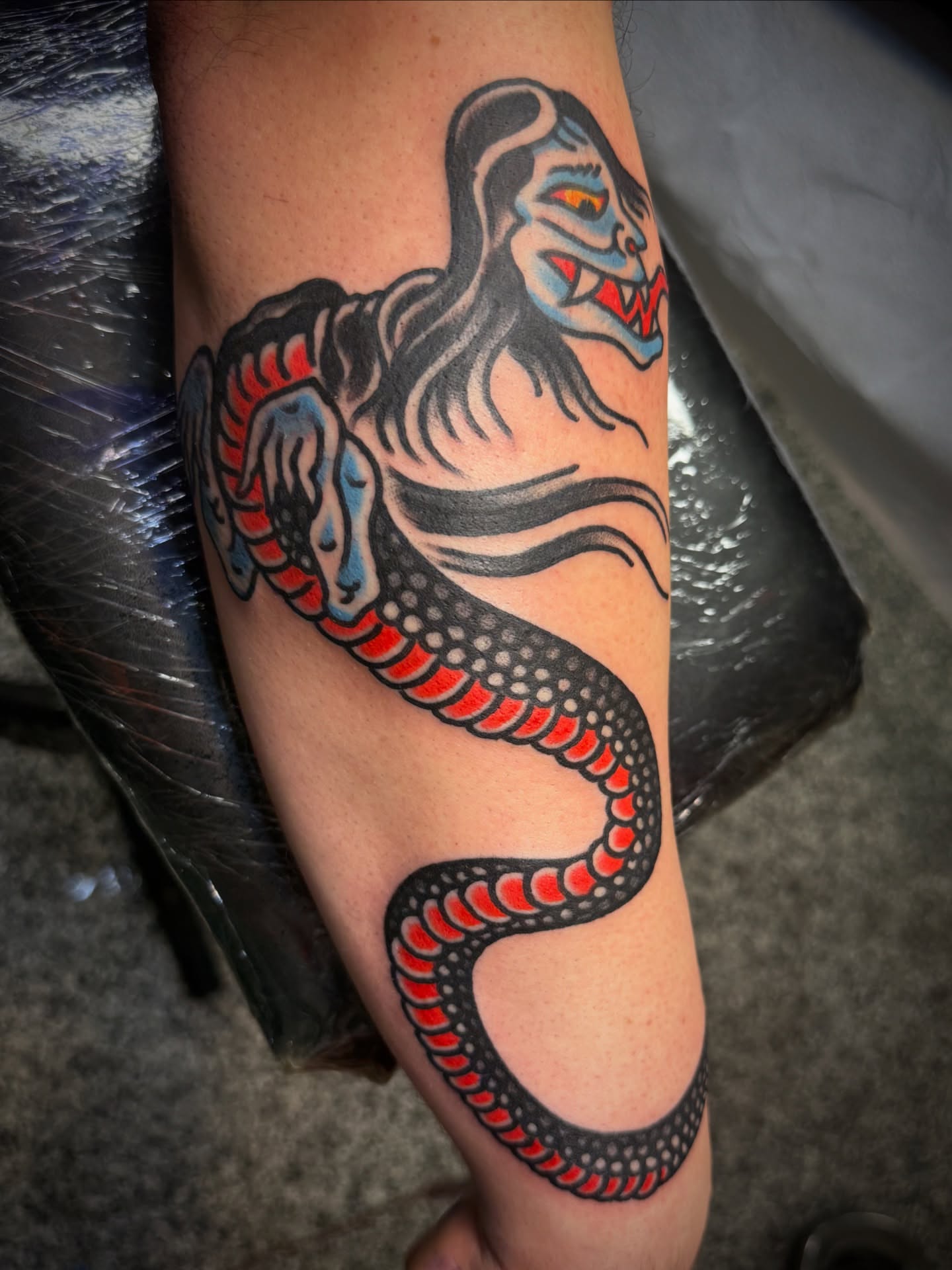 Snake American traditional tattoo on the forearm by Chuck Paprocki, Nashville, Tennessee