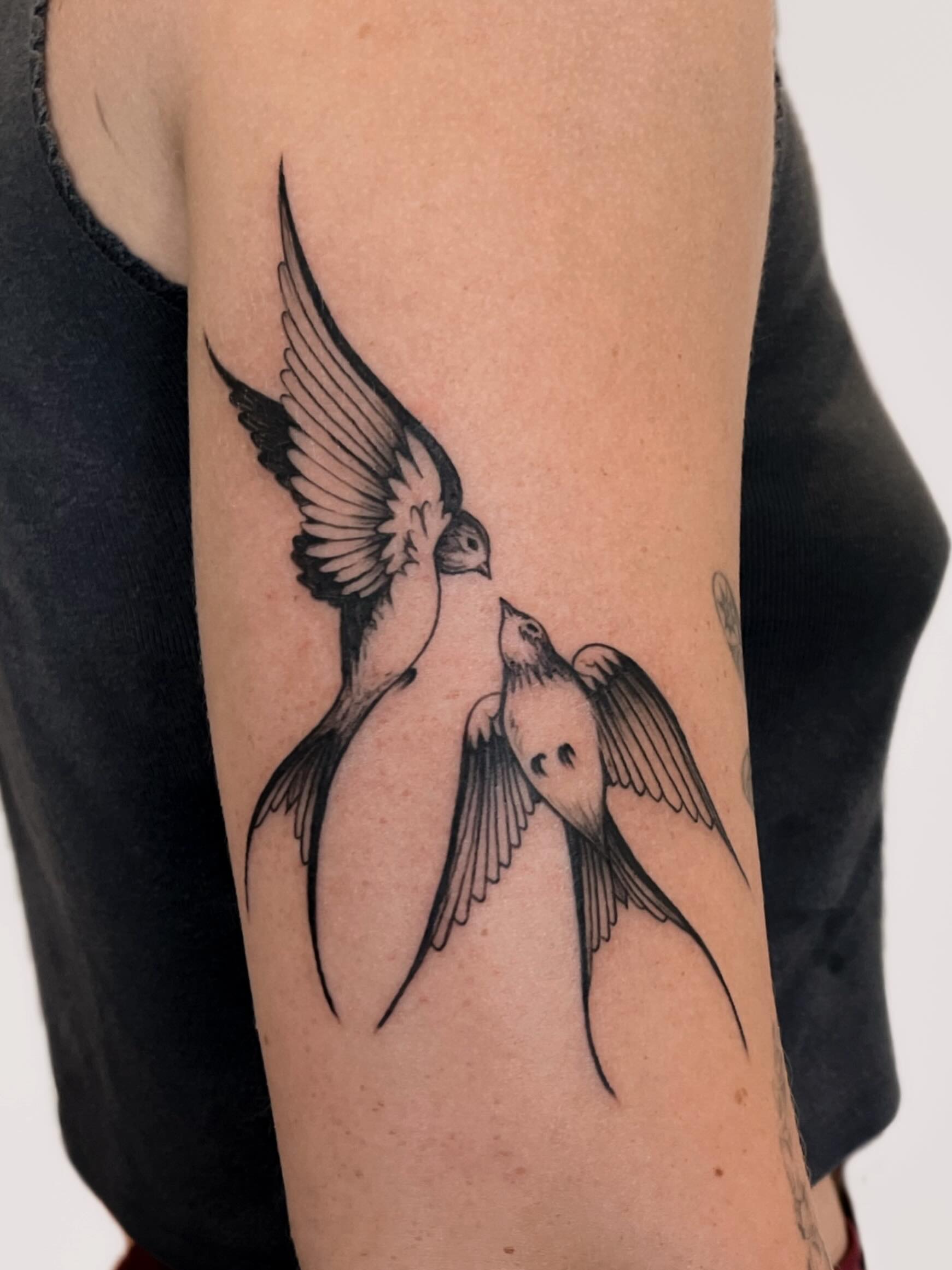 Swallows black and grey tattoo on the forearm by nina