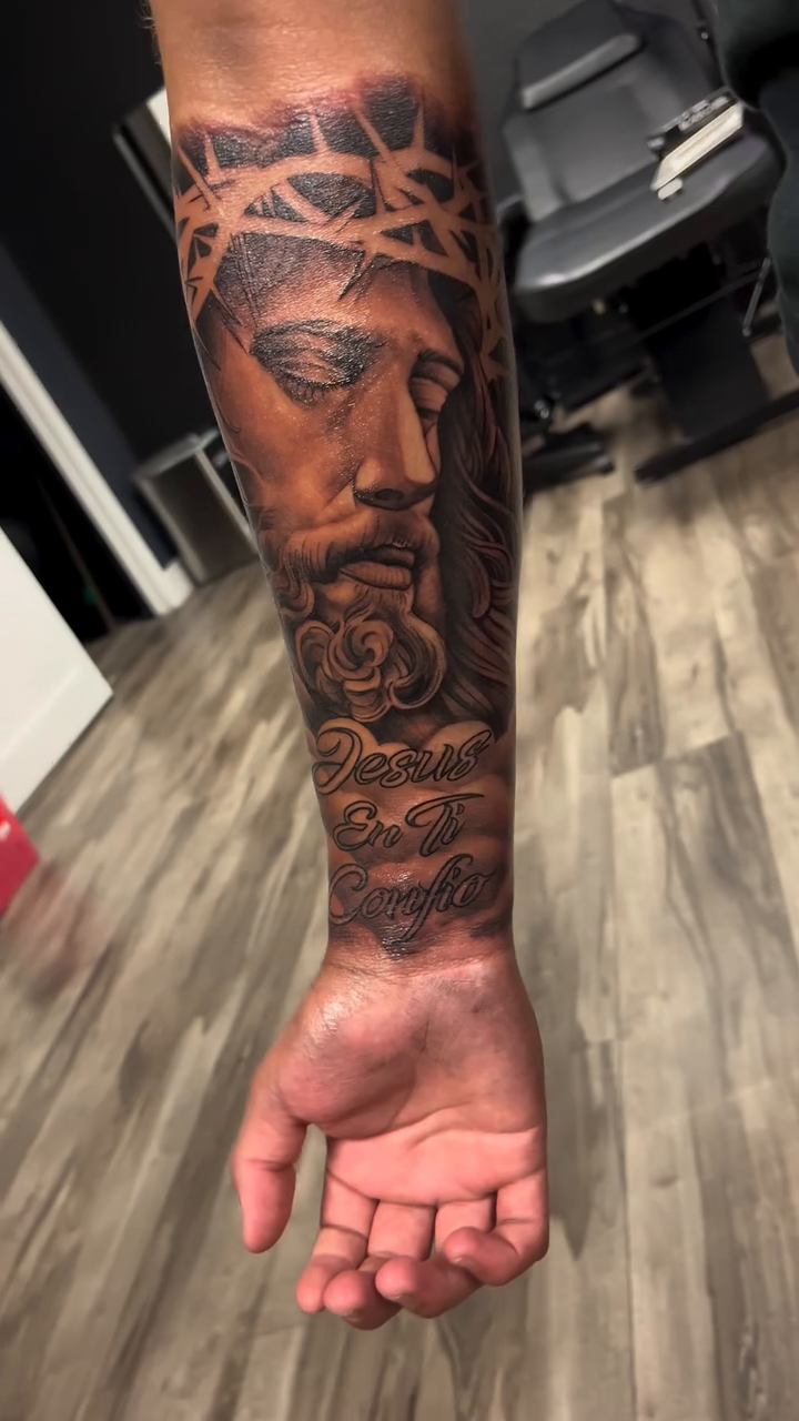 Jesus Christ with roses Chicano tattoo on the forearm by Brian Cruz Garcia