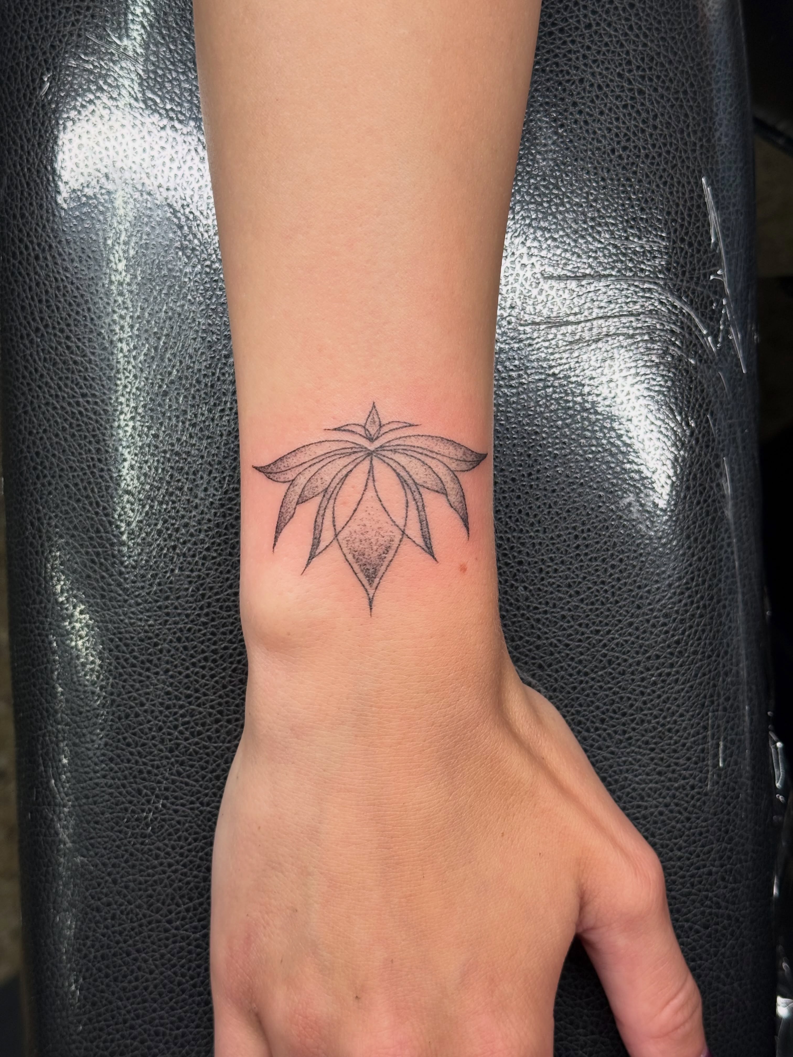 Lotus flower dotwork tattoo on the forearm by Handpoke Tattoo Artist, Minneapolis, Minnesota