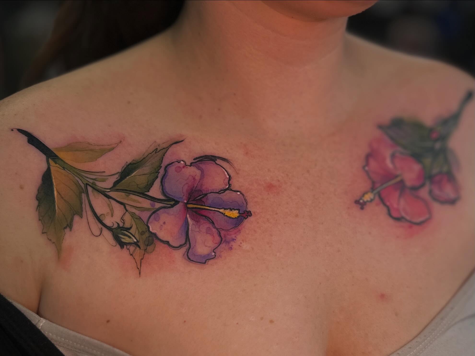 Hibiscus flowers watercolor tattoo on the chest by Mattison Fire 🔥Tallahassee Tattoo Artist