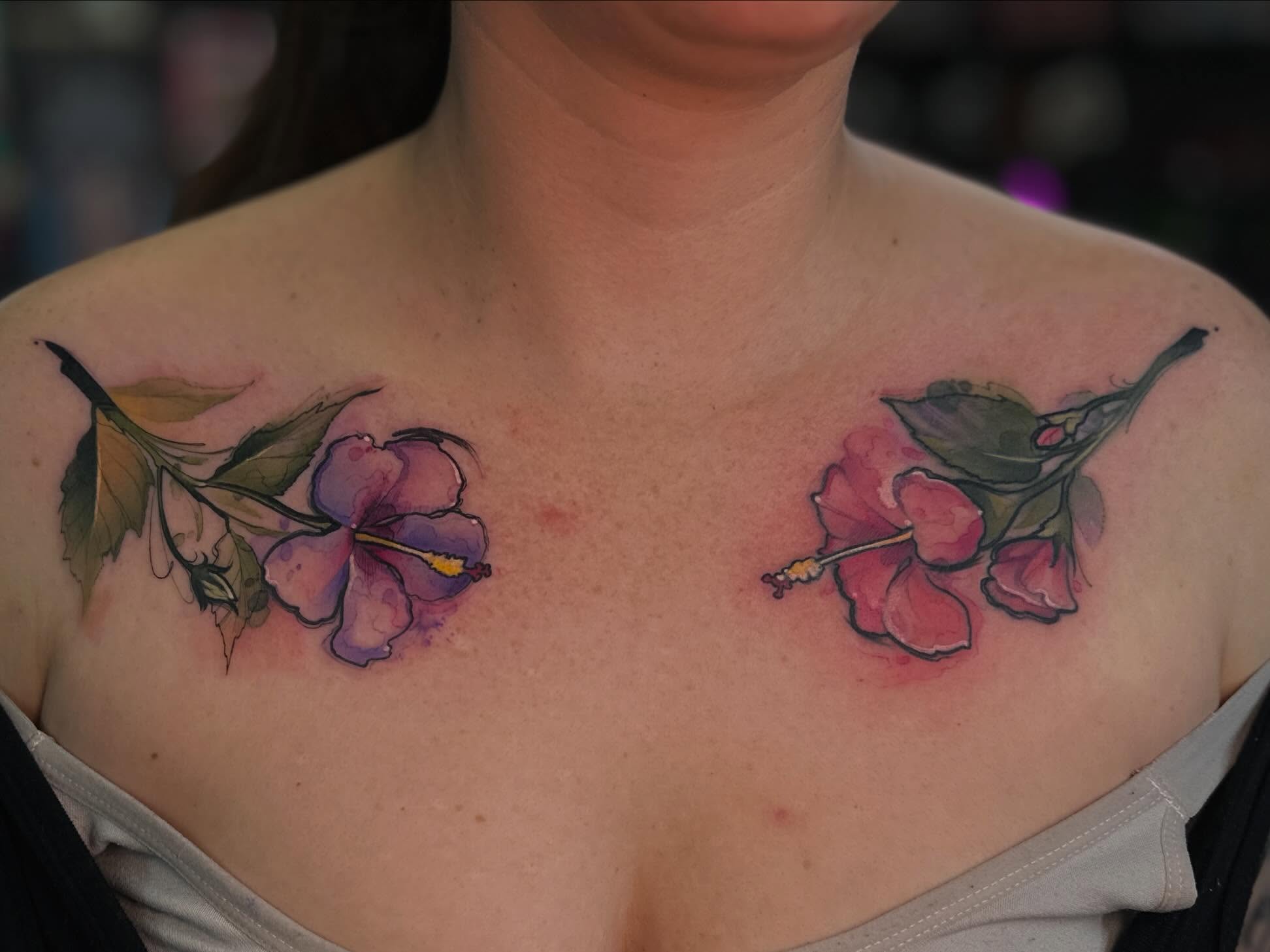 Hibiscus flowers watercolor tattoo on the chest by Mattison Fire 🔥Tallahassee Tattoo Artist