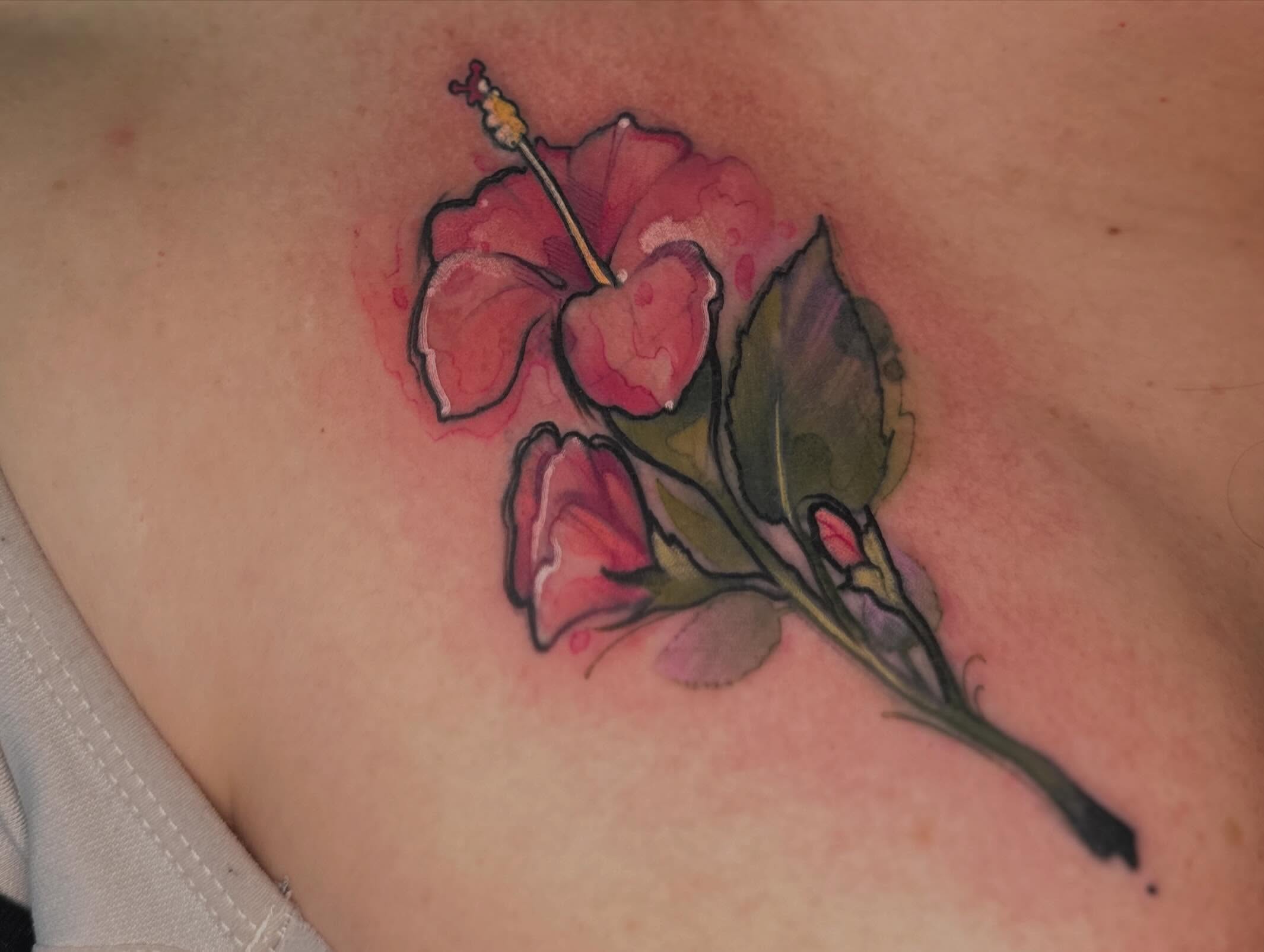 Hibiscus flower watercolor tattoo on the chest by Mattison Fire 🔥Tallahassee Tattoo Artist