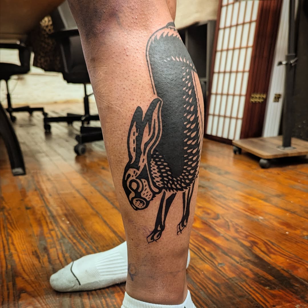 Hare black and grey tattoo on the calf by Eli Studer